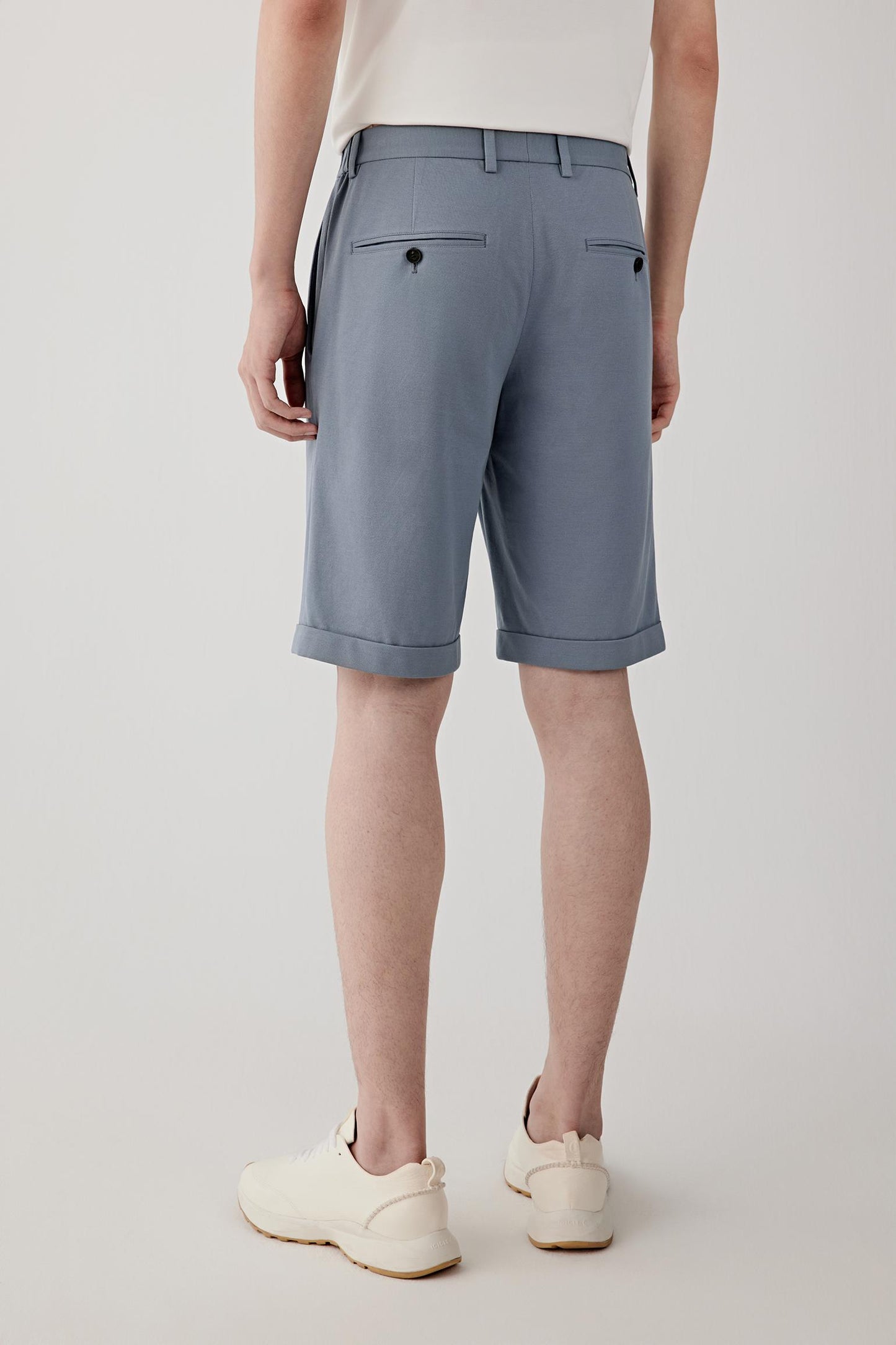 Back view highlighting the clean construction and softly structured jersey surface. The relaxed fit and lightweight cotton piqué create a balanced silhouette with natural movement.