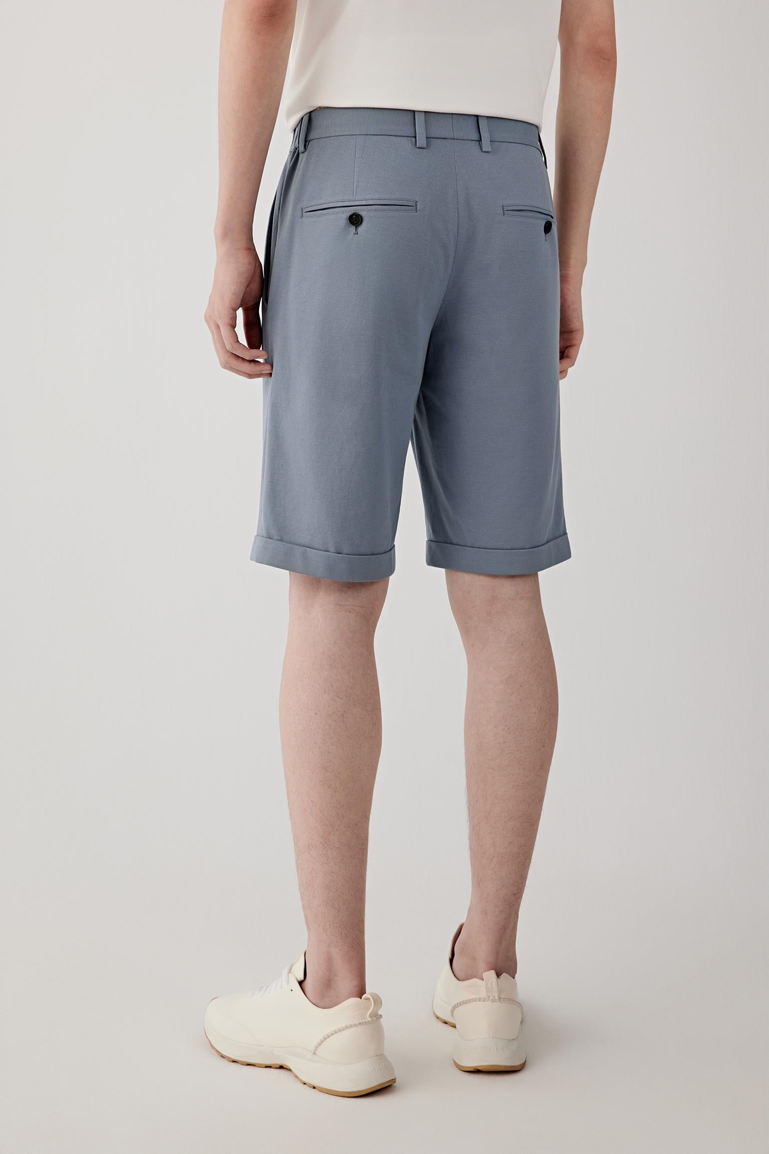 Back view highlighting the clean construction and softly structured jersey surface. The relaxed fit and lightweight cotton piqué create a balanced silhouette with natural movement.