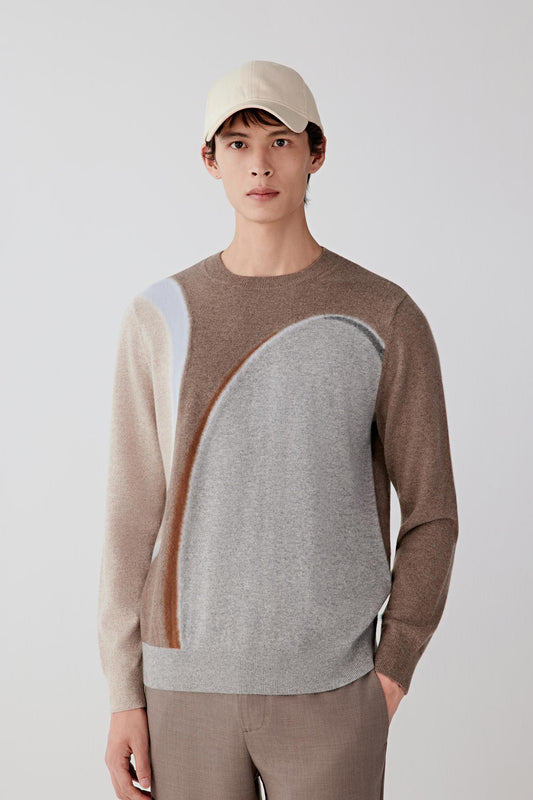 Front view of a cashmere jumper featuring contrasting tonal panels across the chest and shoulders, creating a subtle graphic effect.