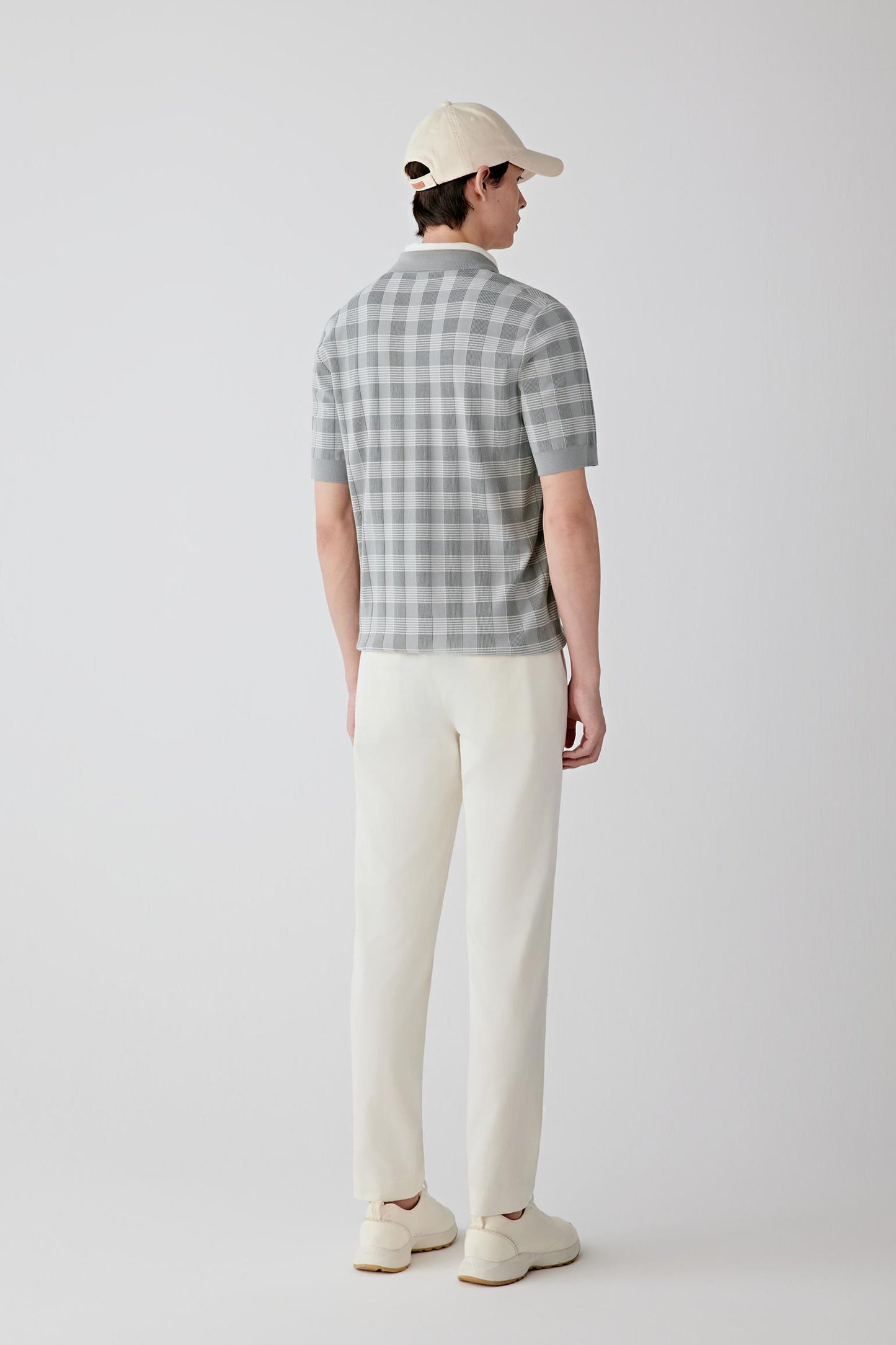 Back view showing the volume through the torso, natural ease at the waist and gentle movement of the lightweight cotton knit.