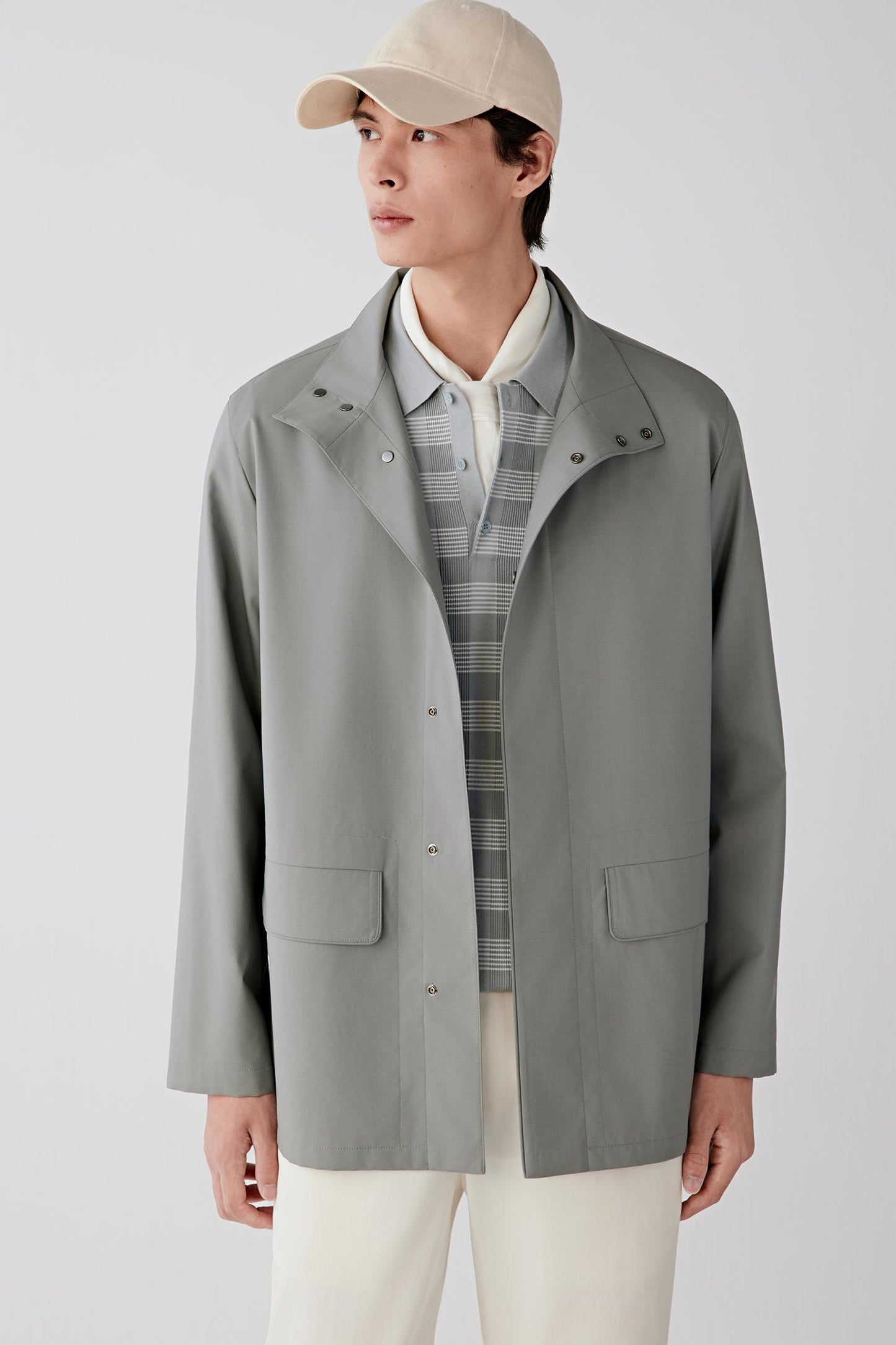 Three-quarter front view showing the clean shoulder line and structured yet fluid silhouette.
