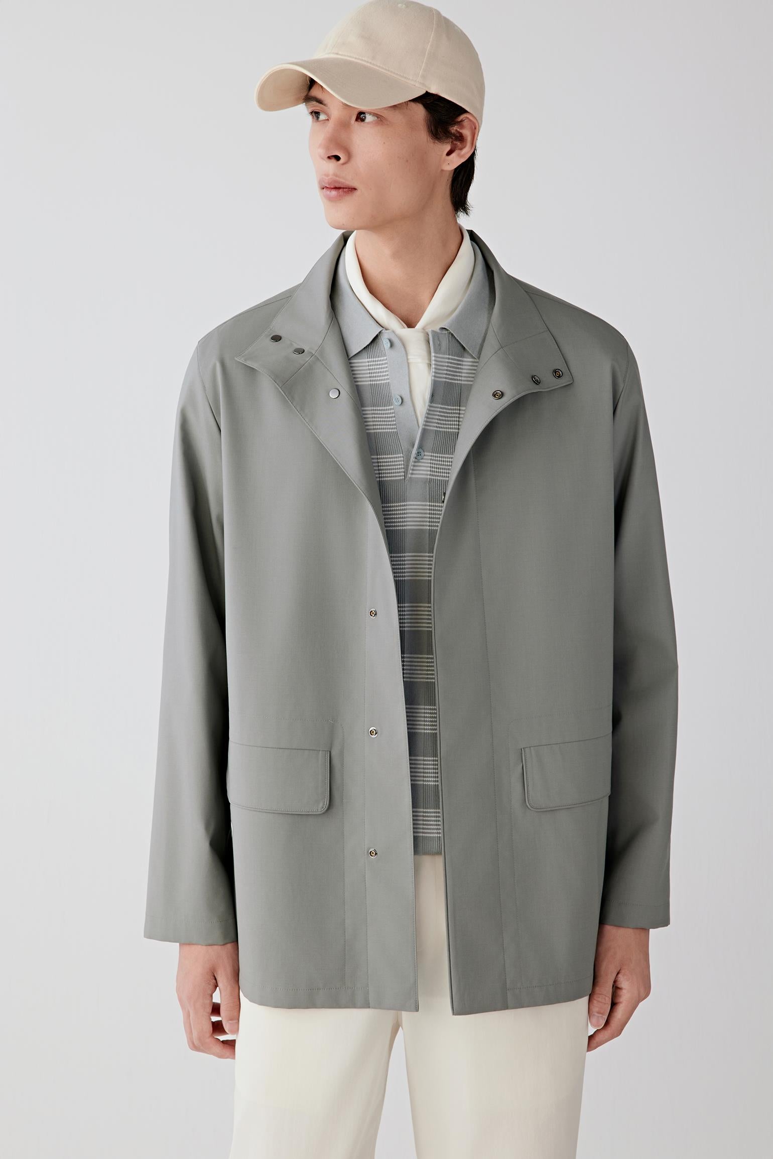 Three-quarter front view showing the clean shoulder line and structured yet fluid silhouette.