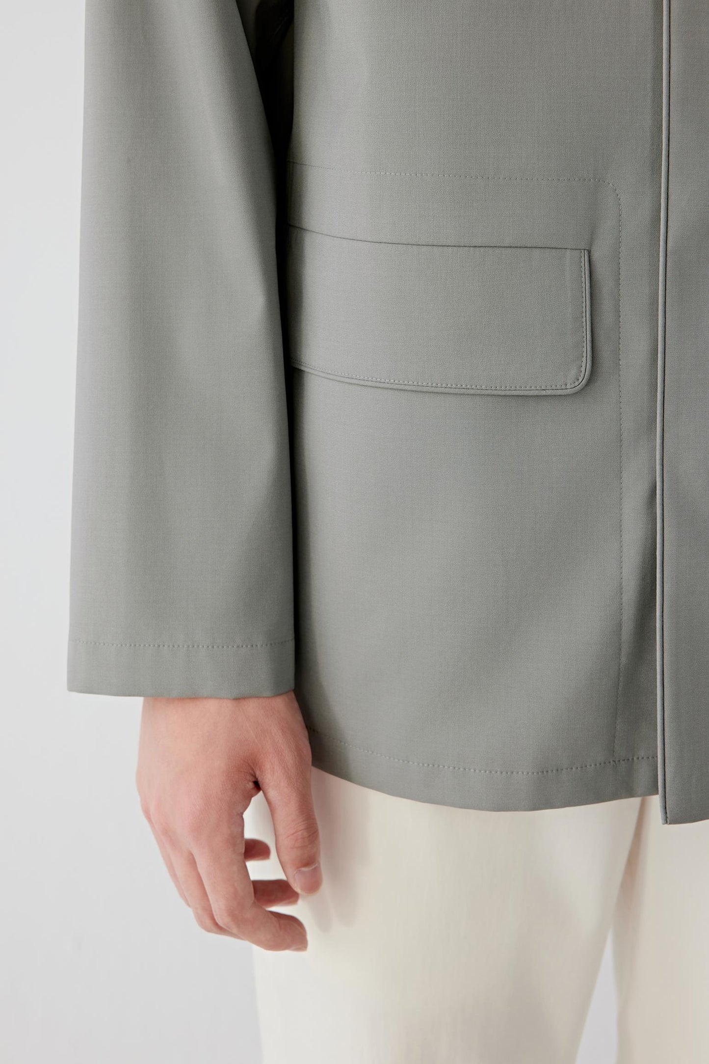 Detail of sleeve cuff and seam finishing, emphasizing refined tailoring.