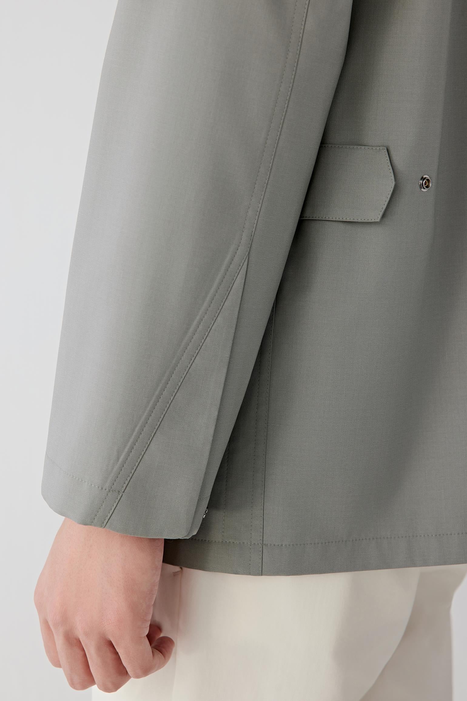 Detail of sleeve cuff and seam finishing, emphasizing refined tailoring.