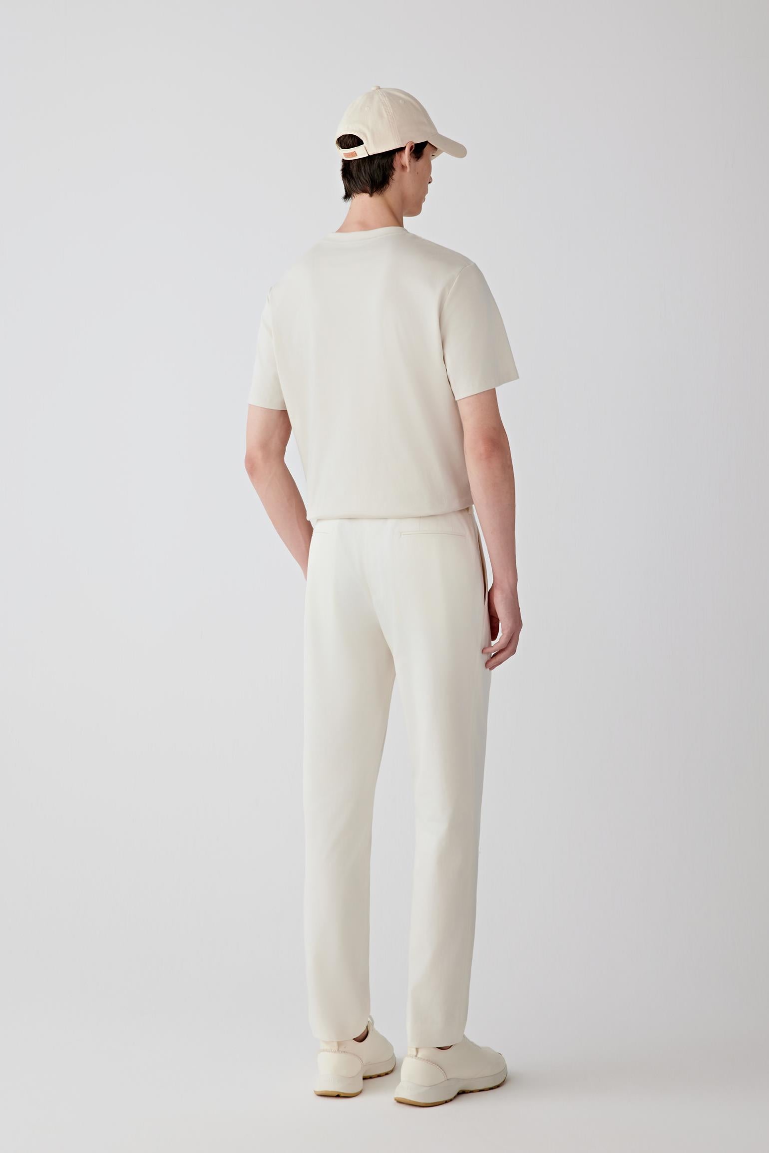 Back view emphasizing the balanced proportions and fluid fall from shoulder to hem, with the T-shirt sitting neatly at the hip.