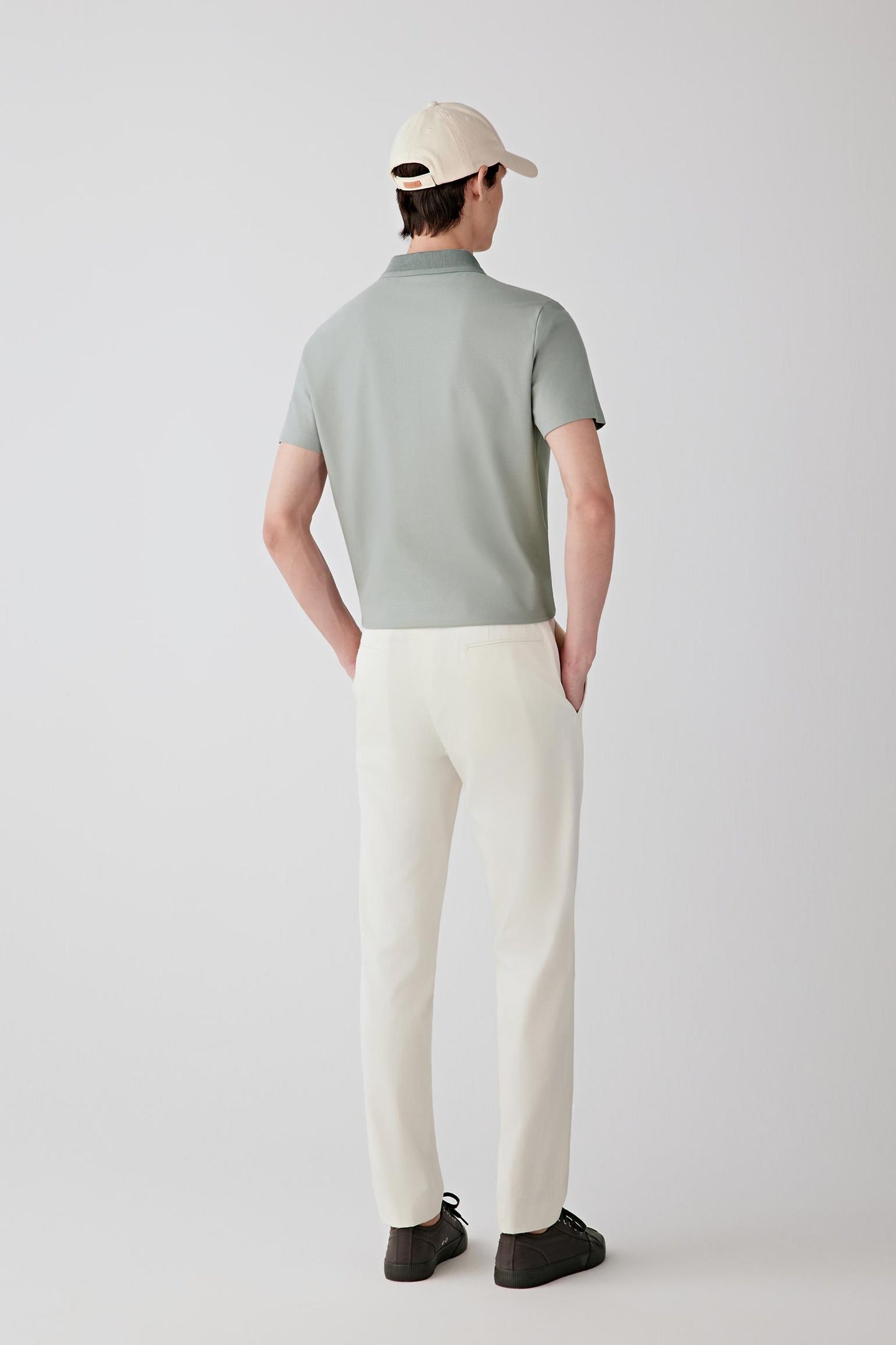 Back view showing the natural fall of the polo and its relaxed structure around the torso.