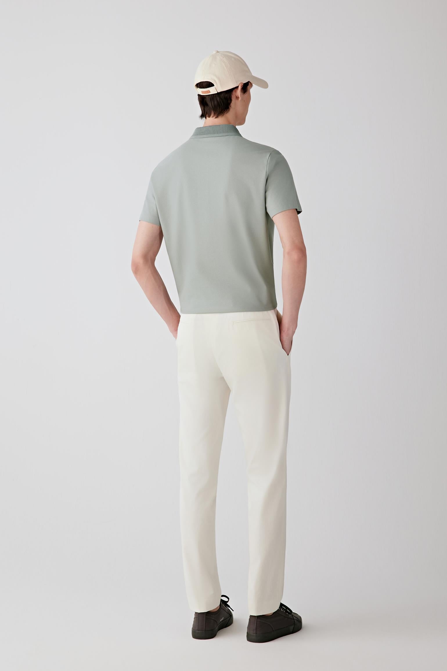 Back view showing the natural fall of the polo and its relaxed structure around the torso.