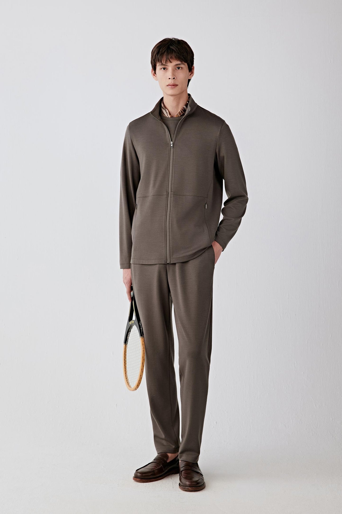 Man wearing a brown Ponte de Roma wool jacket with matching trousers, full-length front view.