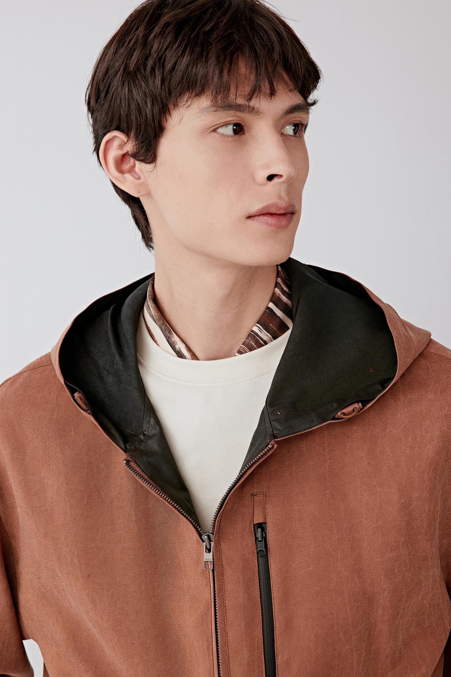 Close-up of hood and neckline detailing with contrasting inner lining.