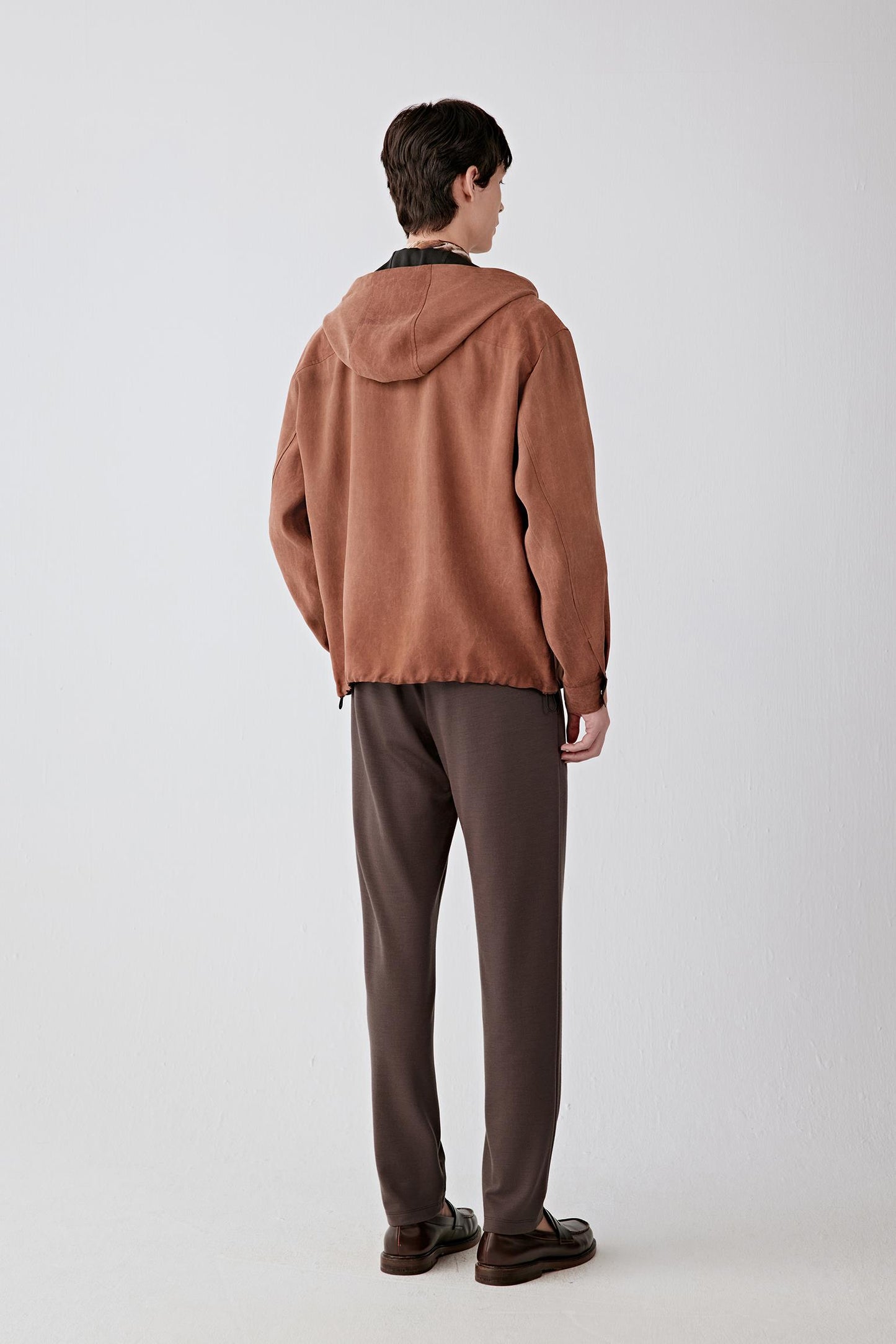 Back view showing the hood structure and straight hemline.