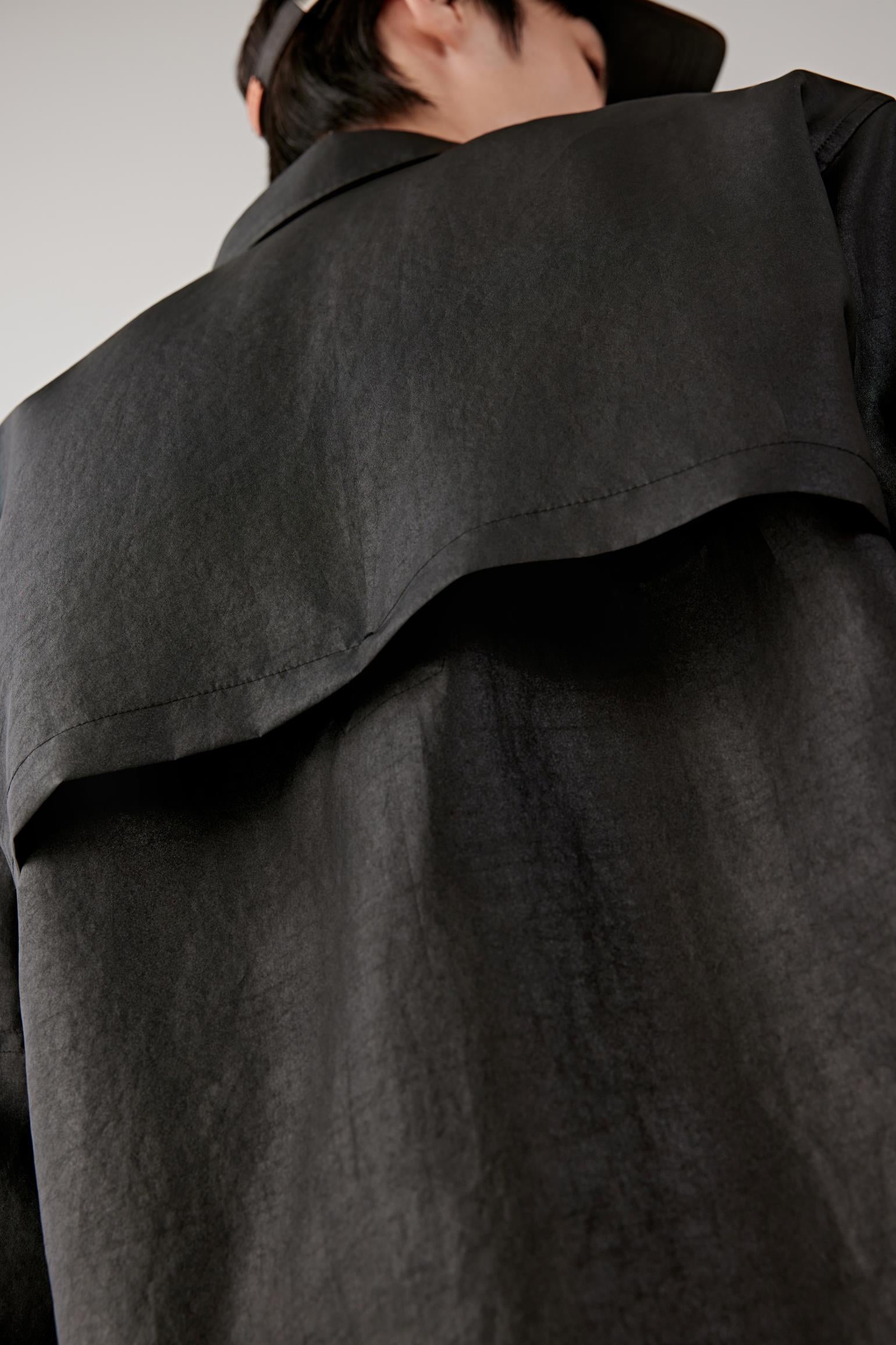 Close-up of the collar and upper chest, revealing the subtle sheen, irregular texture and visible stitching details.