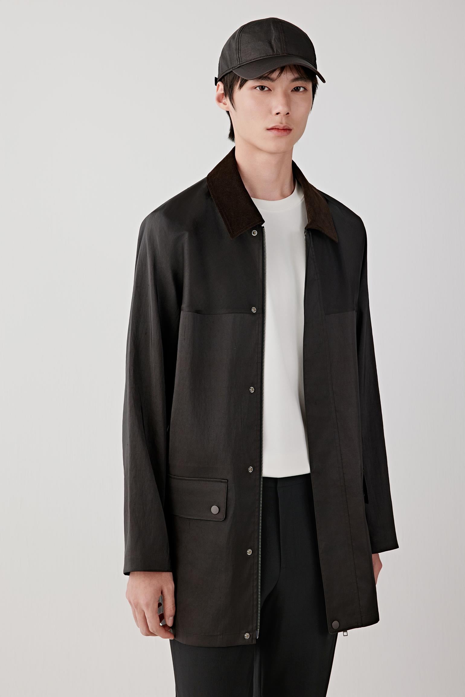 Front three-quarter view highlighting the clean lines, concealed fastening and patch pockets, with a soft, unstructured fall through the torso.