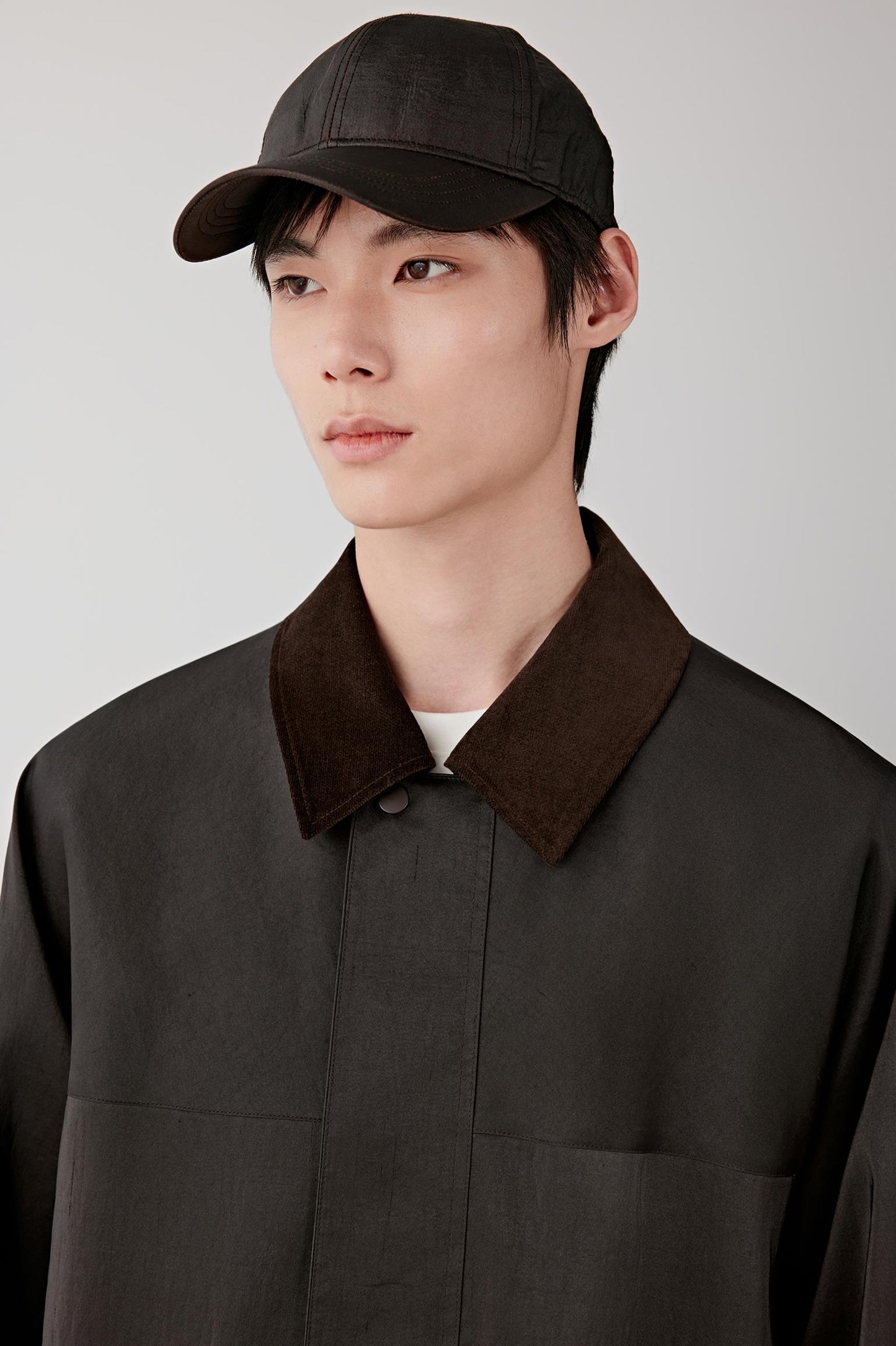 Close-up of the collar and upper chest, revealing the subtle sheen, irregular texture and contrast inner layer detail.