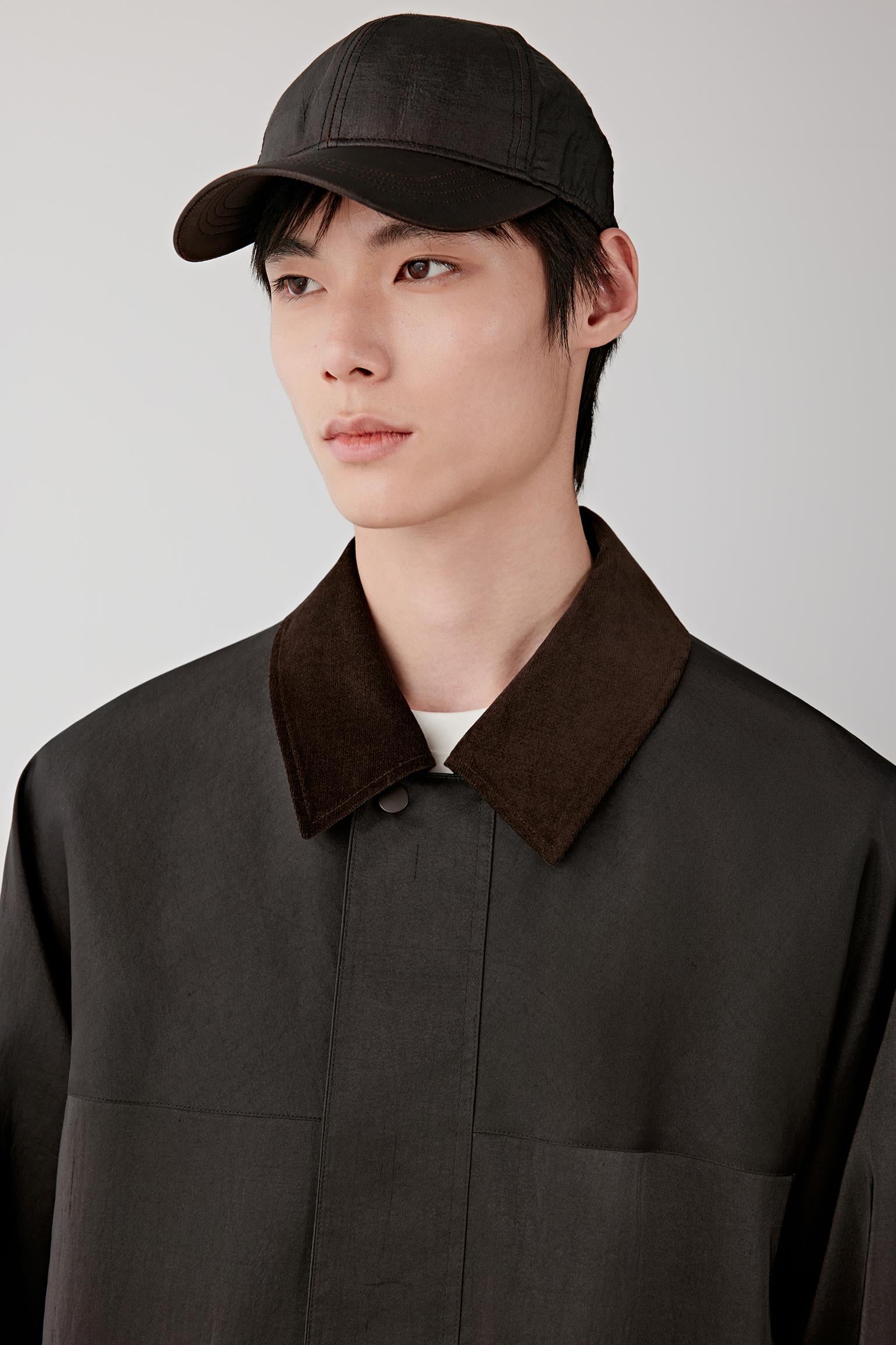 Close-up of the collar and upper chest, revealing the subtle sheen, irregular texture and contrast inner layer detail.