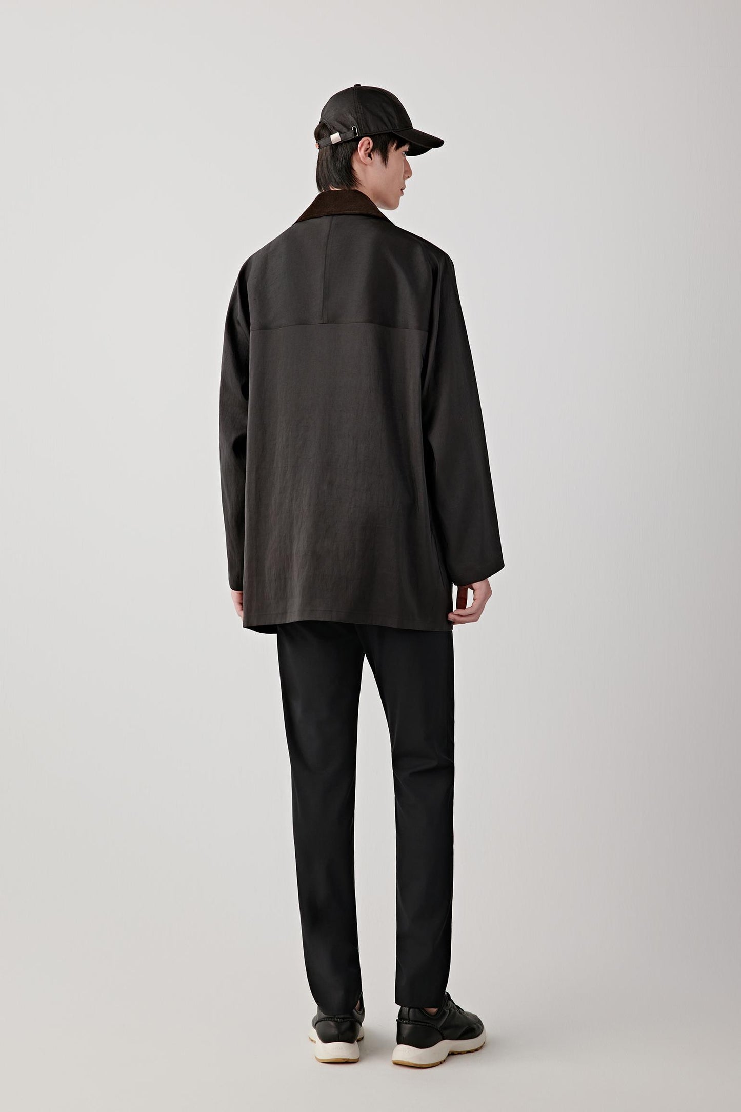 Back view showing the clean back panel, relaxed shoulder line and natural drape of the silk fabric.