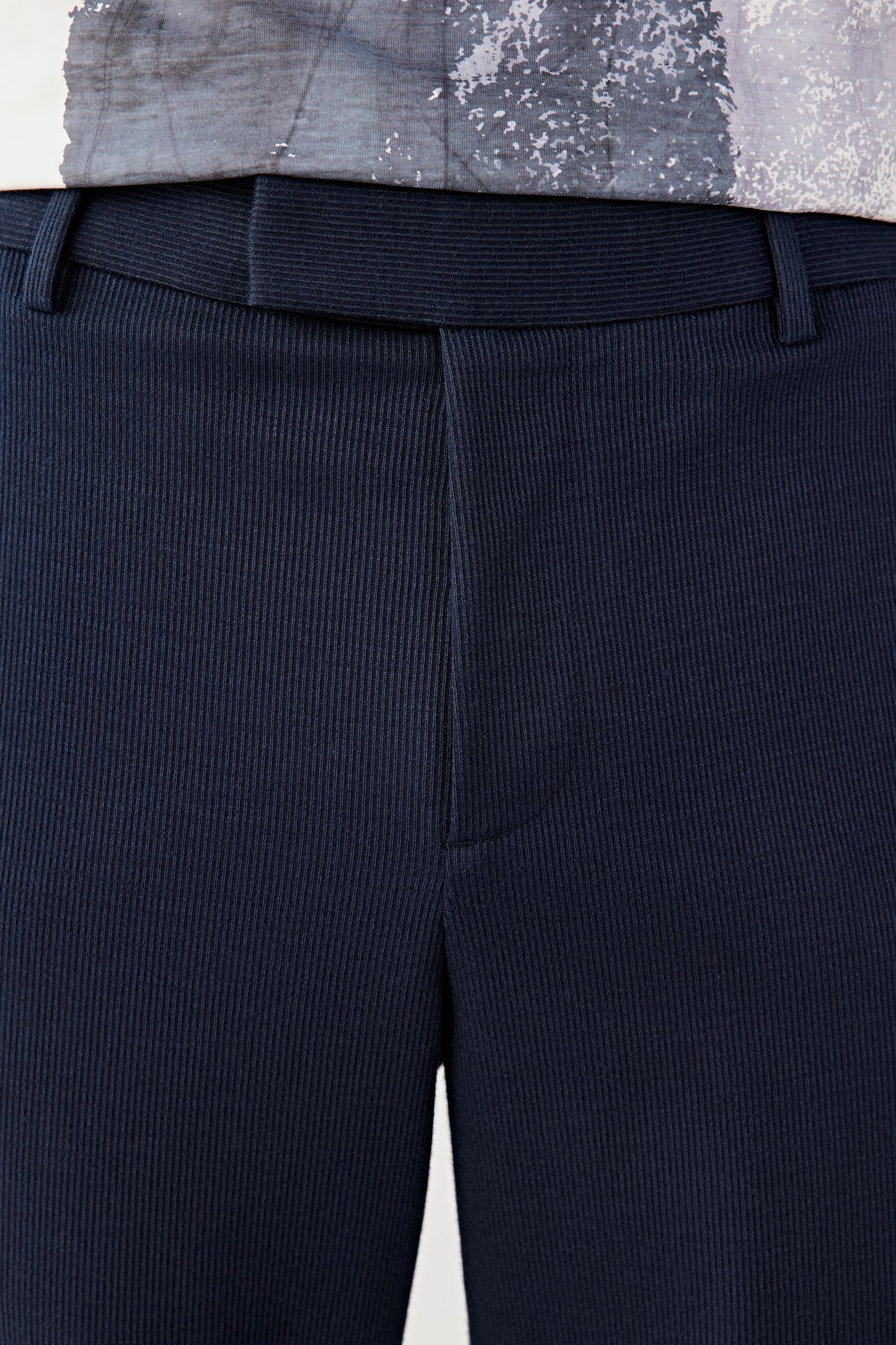 Close-up of the waistband and upper hip, revealing the subtle jacquard texture, clean waistband construction and fine stitching details.