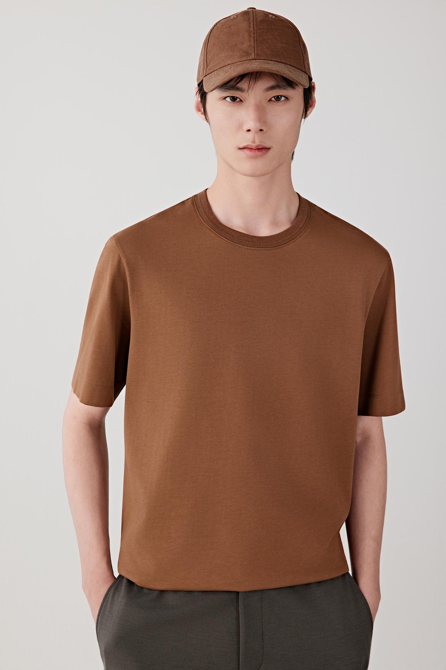 Mid-length front view highlighting the short sleeves, straight cut through the torso and smooth, lightweight jersey texture.