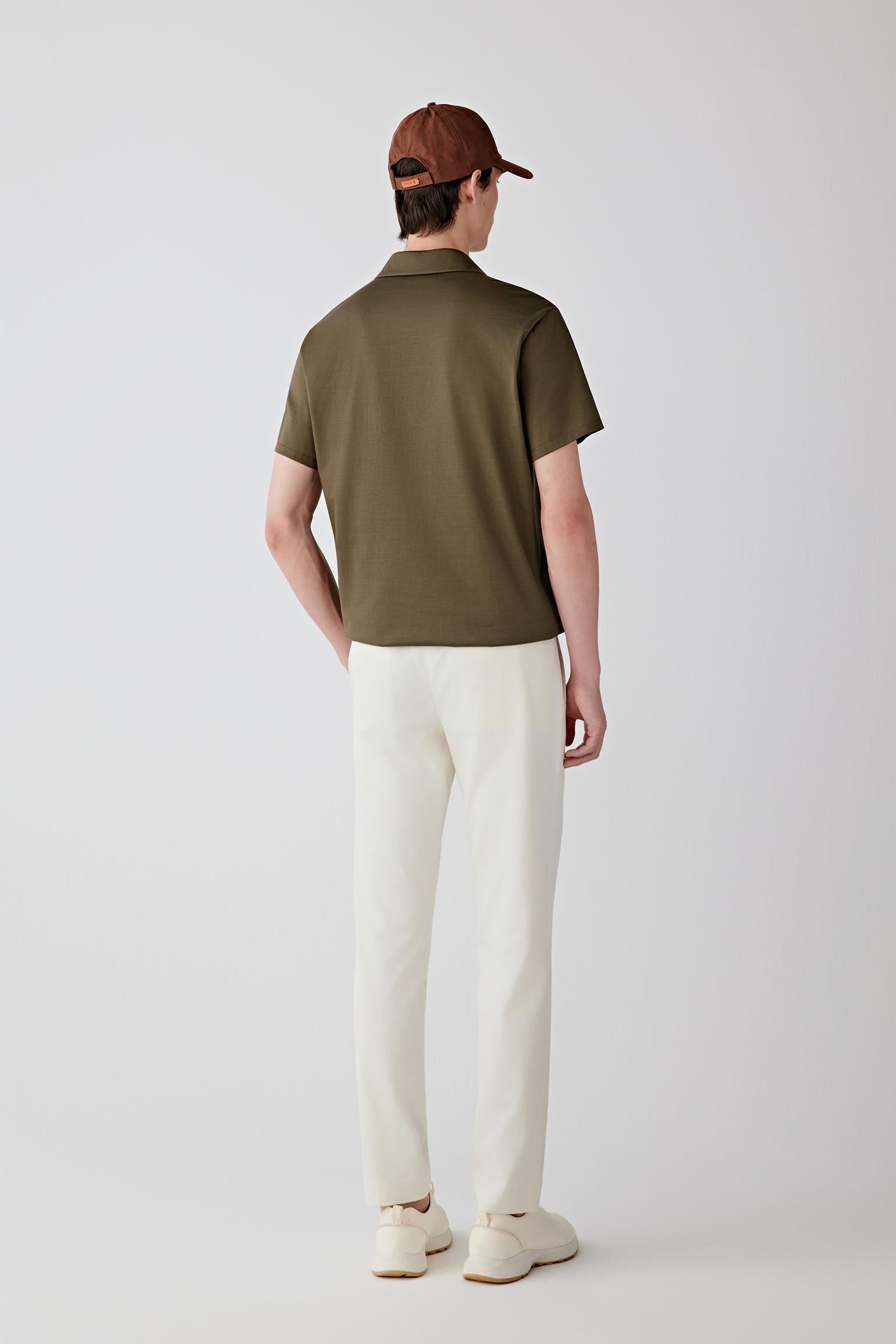 Full-length back view showing the rear silhouette, highlighting the clean shoulder line, straight cut through the body and the natural drape of the lightweight jersey fabric maintaining a continuous line
