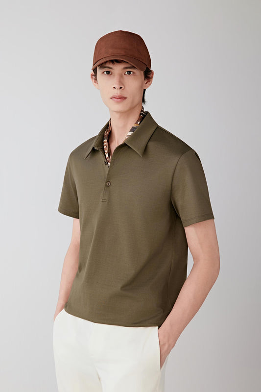 Mid-length front view focusing on the upper body, emphasizing the polo collar, short button placket and short sleeves, with the olive green shade revealing a uniform, matte surface and subtle depth in the fabric