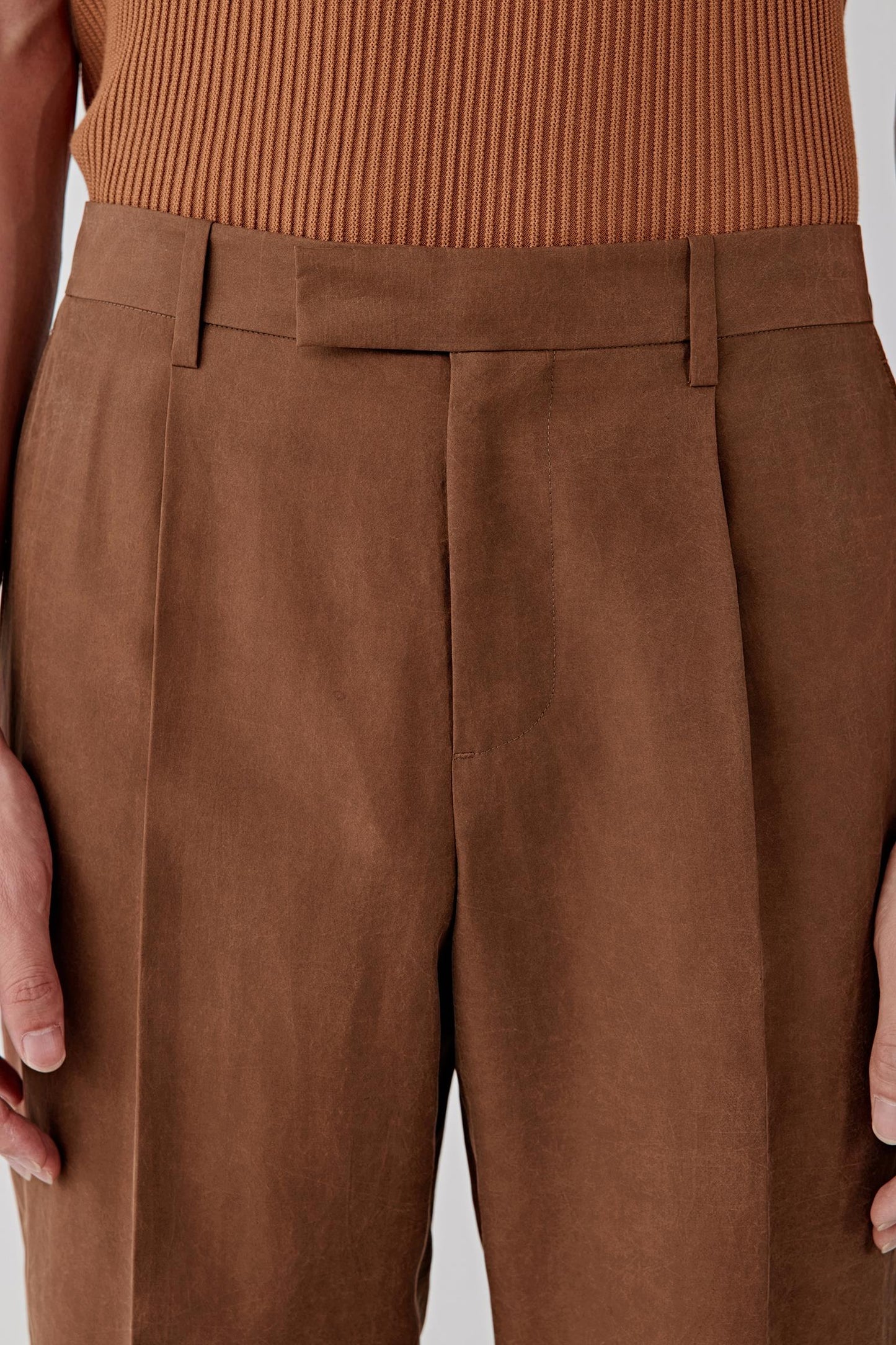 Close-up of the hip and pocket area, detailing the clean pocket construction, stitching lines and the dense yet breathable fabric surface, with subtle variations in the deep brown shade enhancing texture