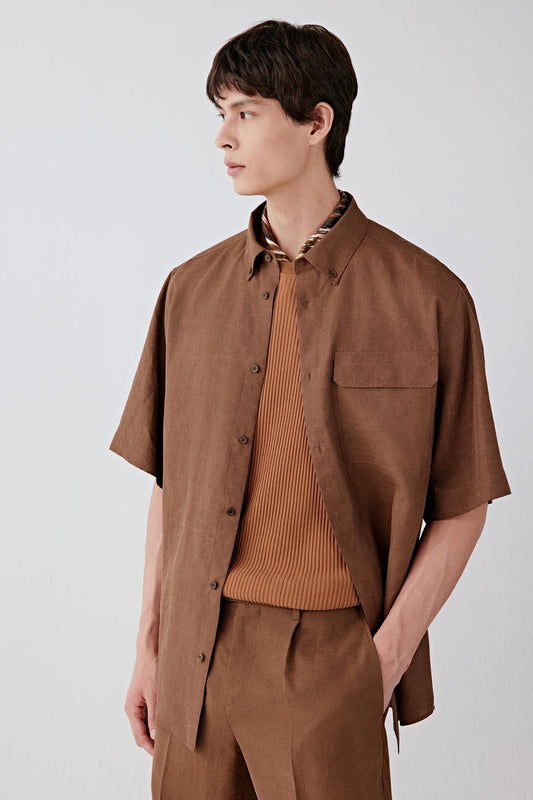 Three-quarter front view focusing on the upper body, emphasizing the short sleeves, button-down collar and front placket, with visible stitching and a structured yet breathable fabric that holds shape while remaining lightweight