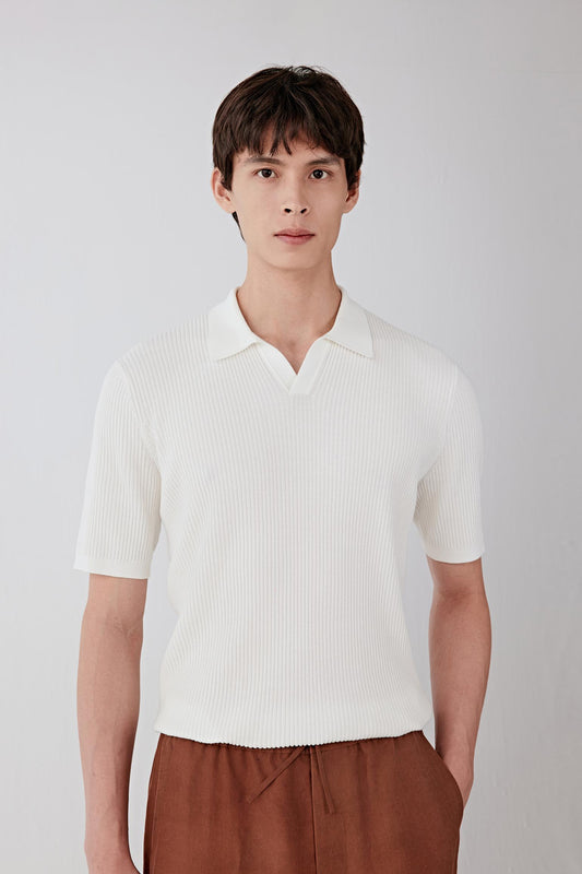 Mid-length front view focusing on the upper body, emphasizing the short collar, subtle V opening and the fine ribbed knit construction, with a smooth, matte surface