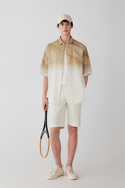 Full-length front view showing the relaxed short-sleeve silhouette and lightweight structure. The silk taffeta maintains volume and shape while allowing fluid movement through the garment.