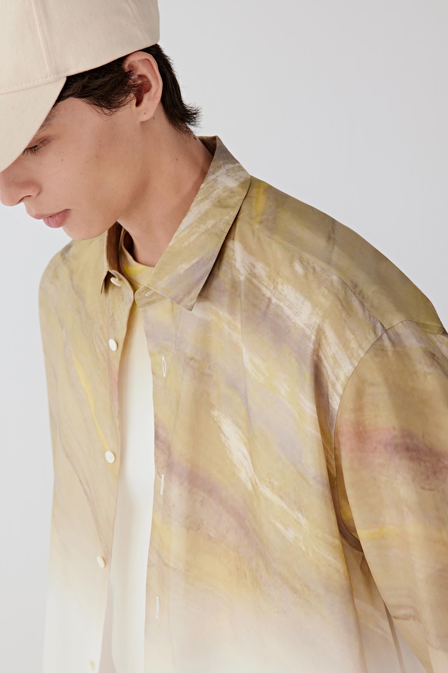 Close-up portrait focusing on the classic collar and button fastening, detailing the smooth silk taffeta surface, subtle sheen and tonal transitions within the fabric.