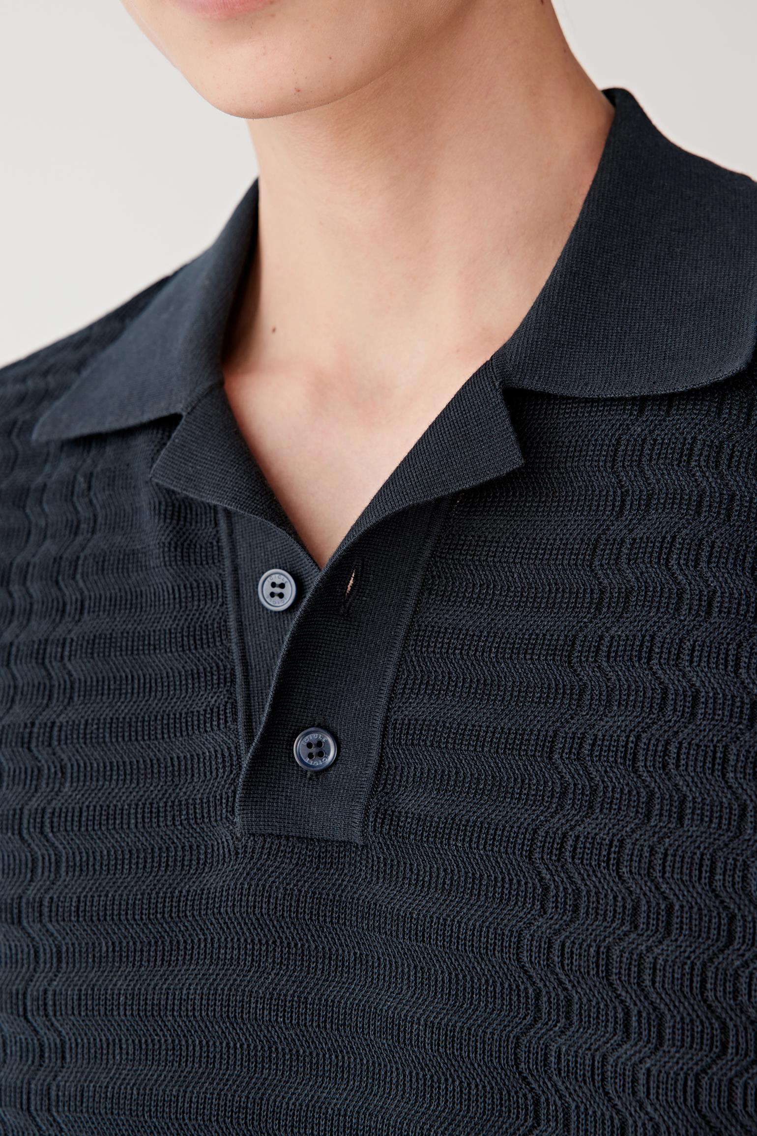 Close-up front view showing the polo collar and short sleeve construction. The lightweight knit maintains a clean and relaxed silhouette with subtle structure.