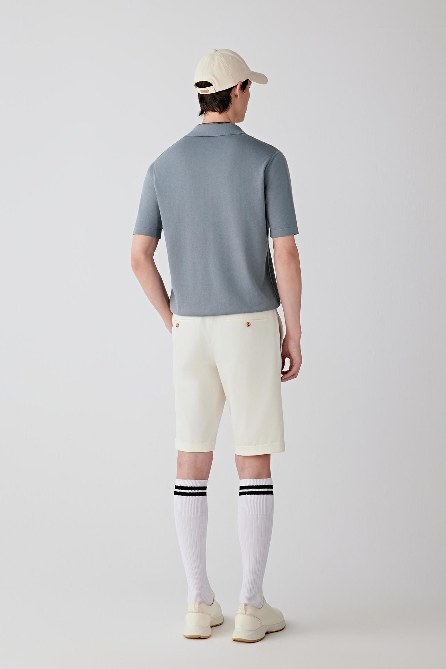 Side or three-quarter view emphasizing the fluid drape and relaxed proportions of the silhouette. The fine-spun cotton knit creates a smooth continuous line with natural ease of movement.