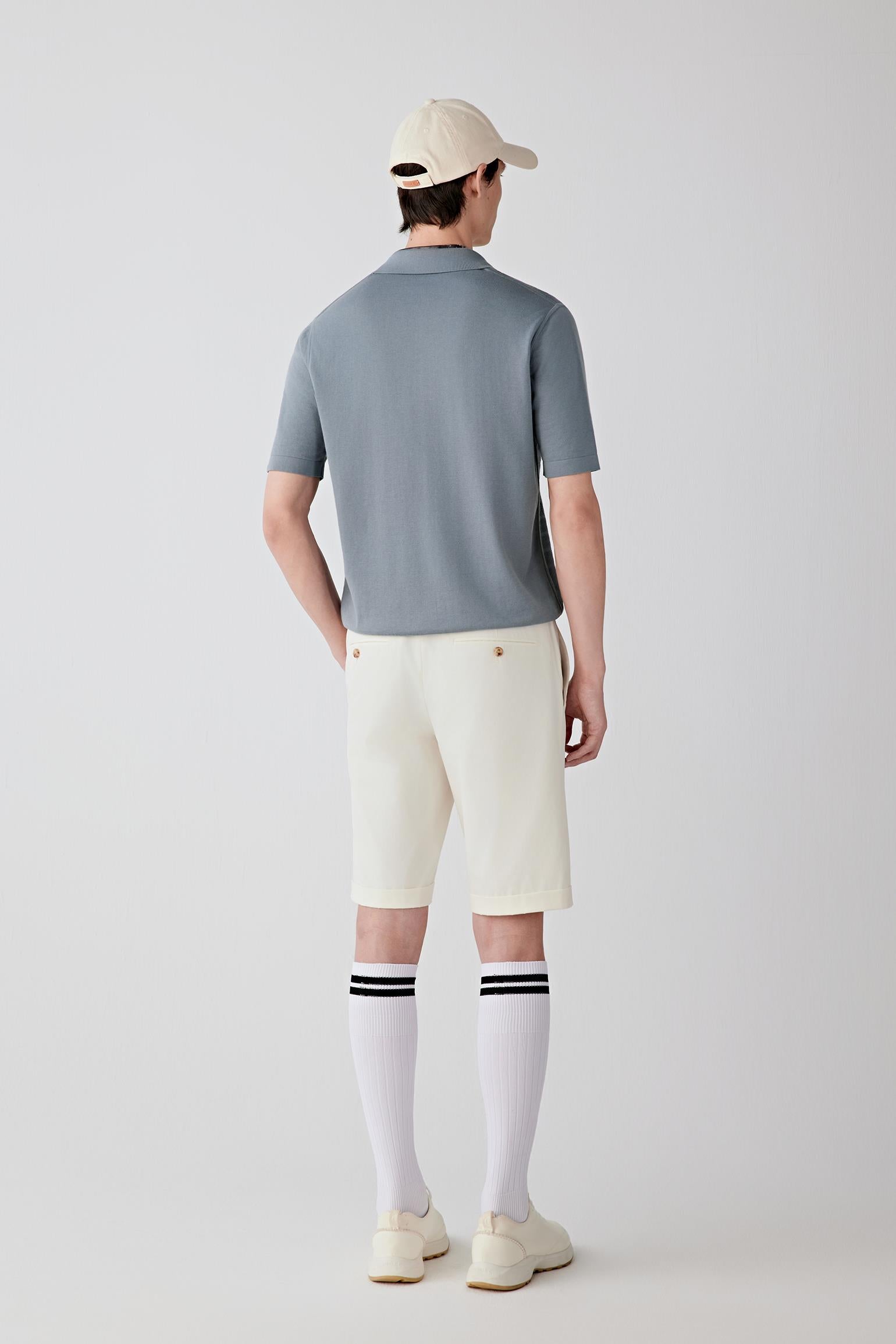 Side or three-quarter view emphasizing the fluid drape and relaxed proportions of the silhouette. The fine-spun cotton knit creates a smooth continuous line with natural ease of movement.