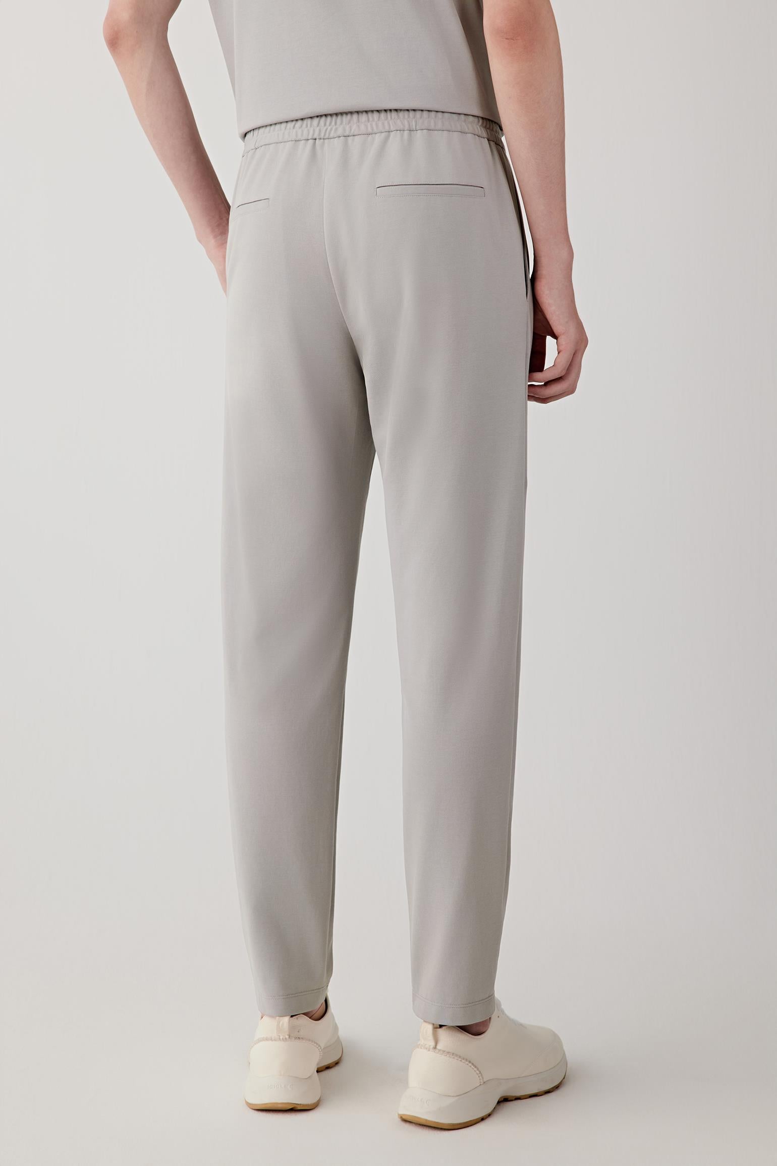 Side or back view emphasizing the fluid line of the straight-leg cut and the lightweight jersey construction. The relaxed silhouette moves naturally with the body.