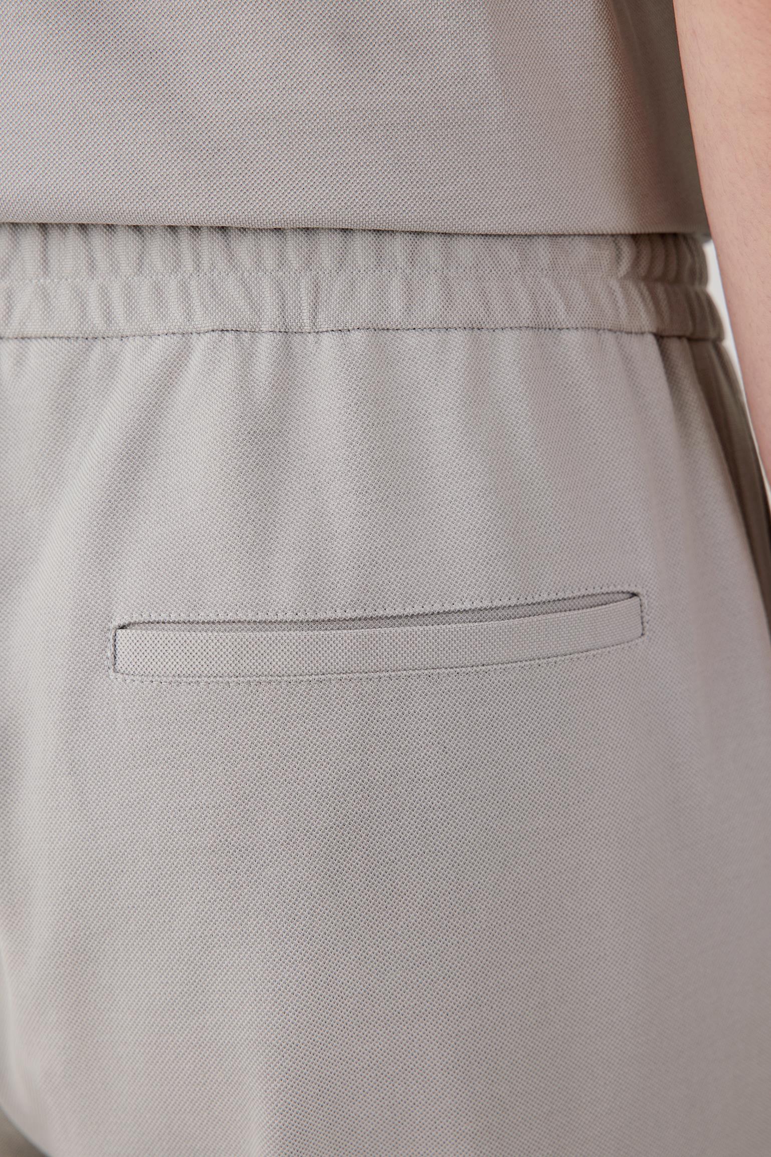 Close-up of the fabric and back pocket construction showing the lightly textured piqué surface, clean stitching and soft matte finish of the jersey material.