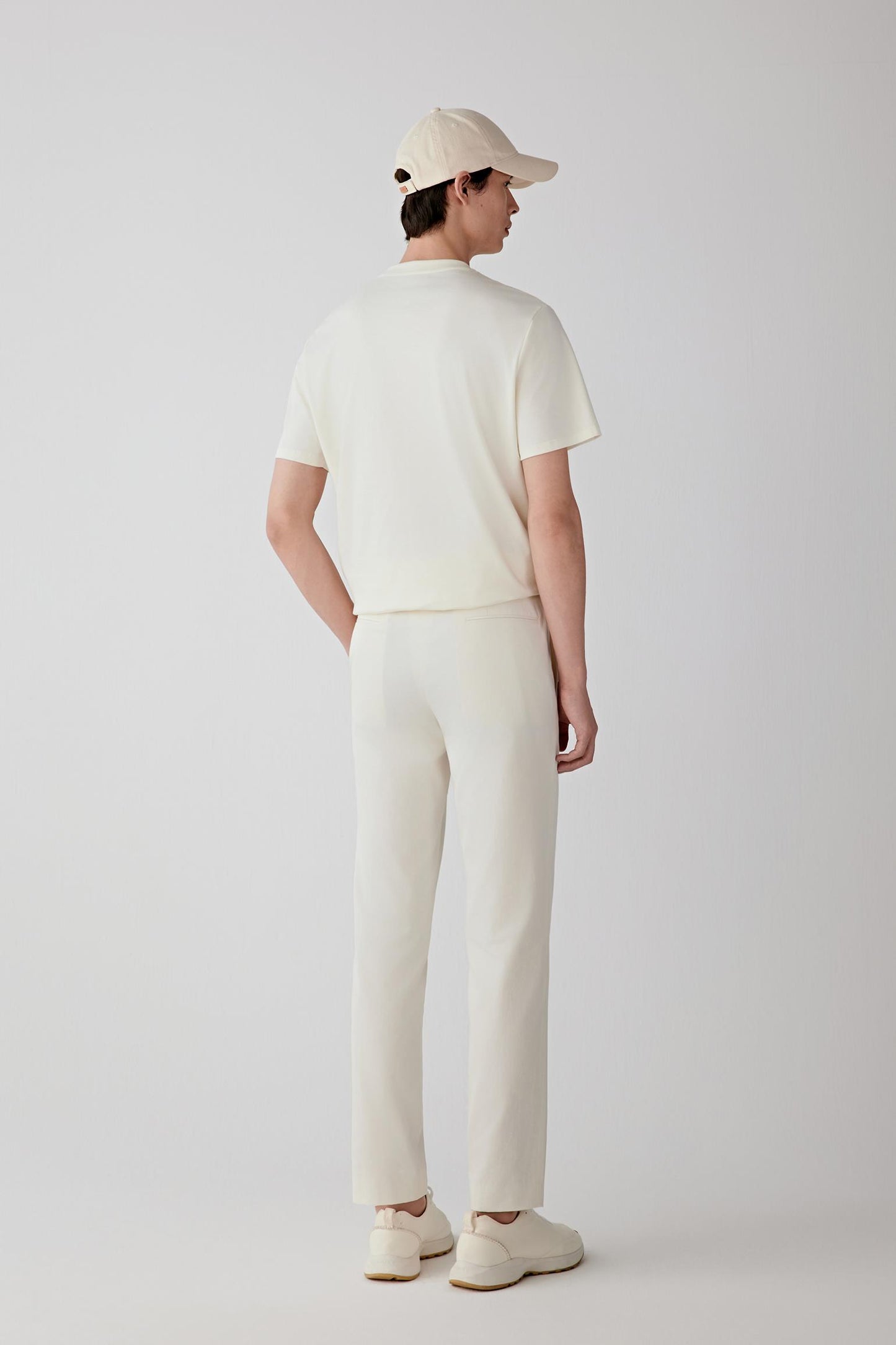 Full-length view highlighting the straight cut, crew neckline and clean lines of the garment. The dense cotton interlock maintains a smooth appearance while providing subtle structure throughout the silhouette.