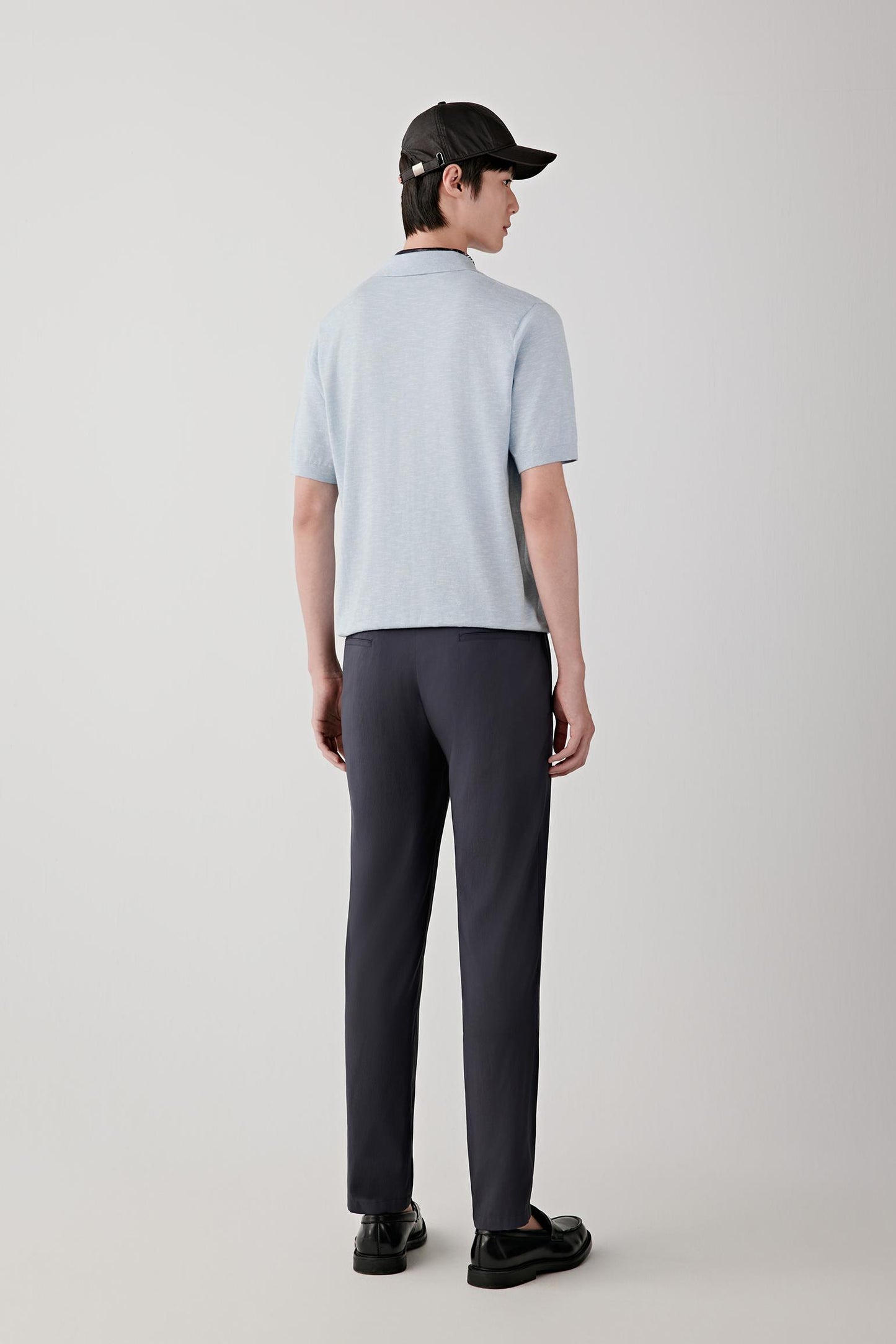 Side view highlighting the straight cut, short sleeves and natural drape of the cotton and silk blend. The lightweight knit follows the body softly while maintaining a clean silhouette.