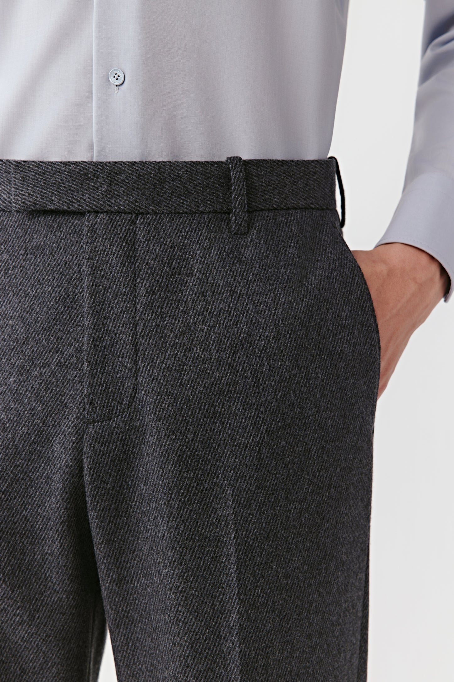 Gray dress shirt and dark gray trousers on a white background