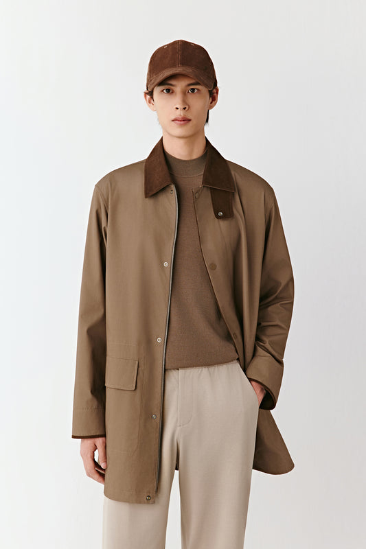 A mid-length frame captures the harmony of tones and the clean cut of the jacket.