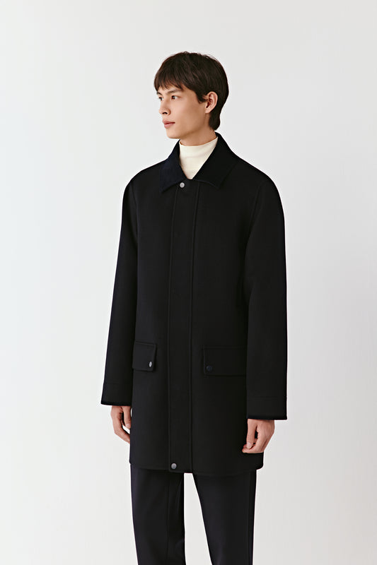 Person wearing a black coat on a white background