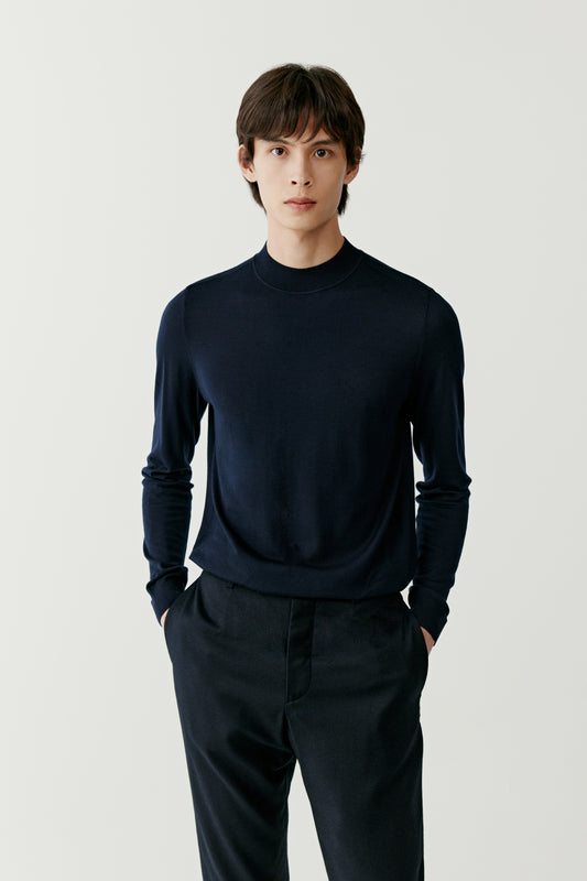 A mid-length frame captures the relaxed posture and clean lines of the jumper.
