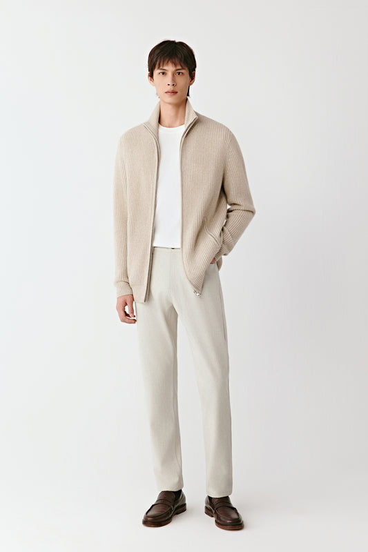 Front view of the cream undyed cashmere zip cardigan, featuring a stand collar and ribbed cuffs.