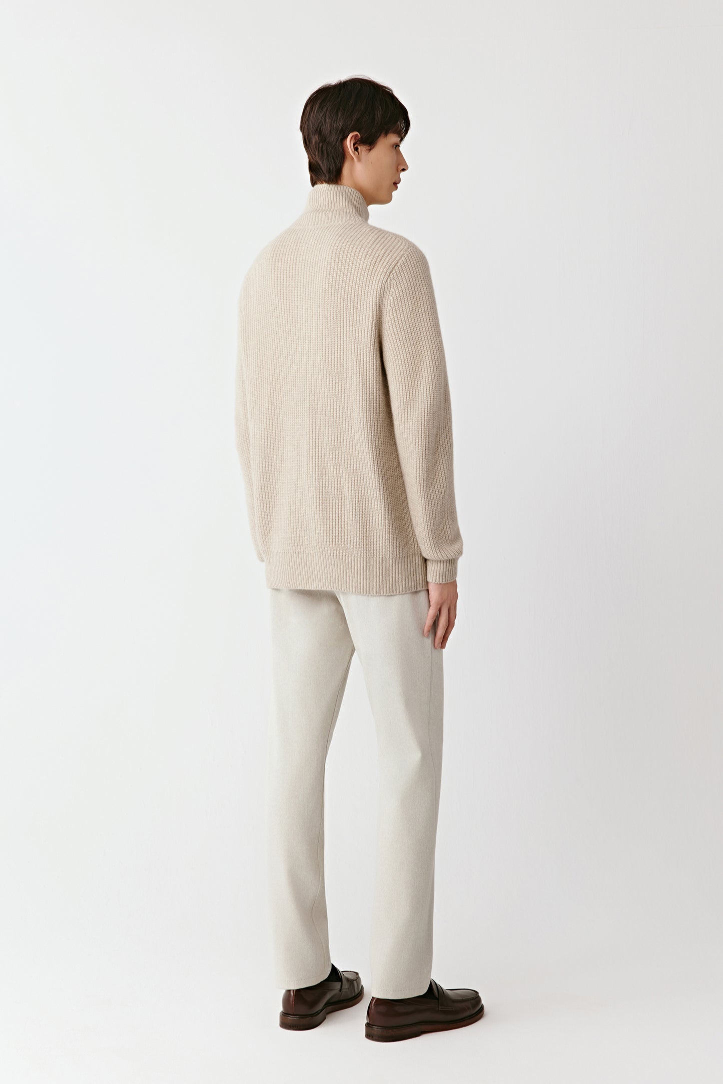 Back view of the cardigan, highlighting the smooth drape and refined finishing.