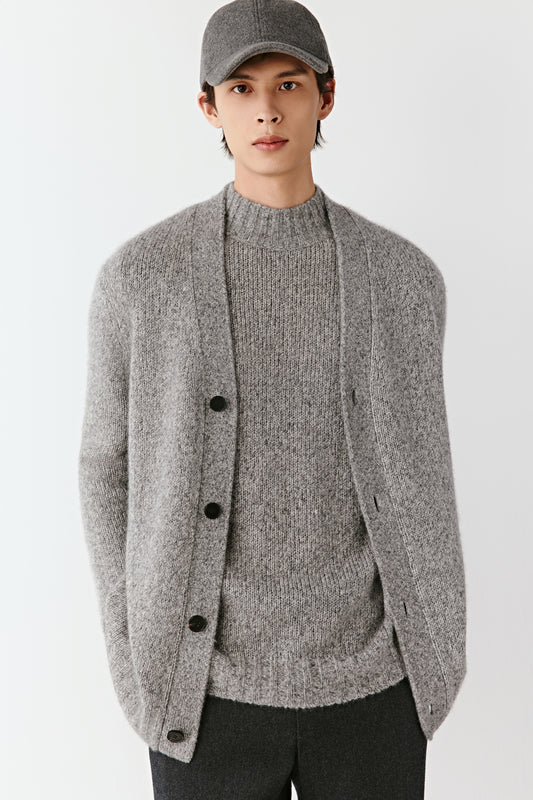 Three-quarter view of the twisted yarn cardigan, showing the fluid drape and soft texture.
