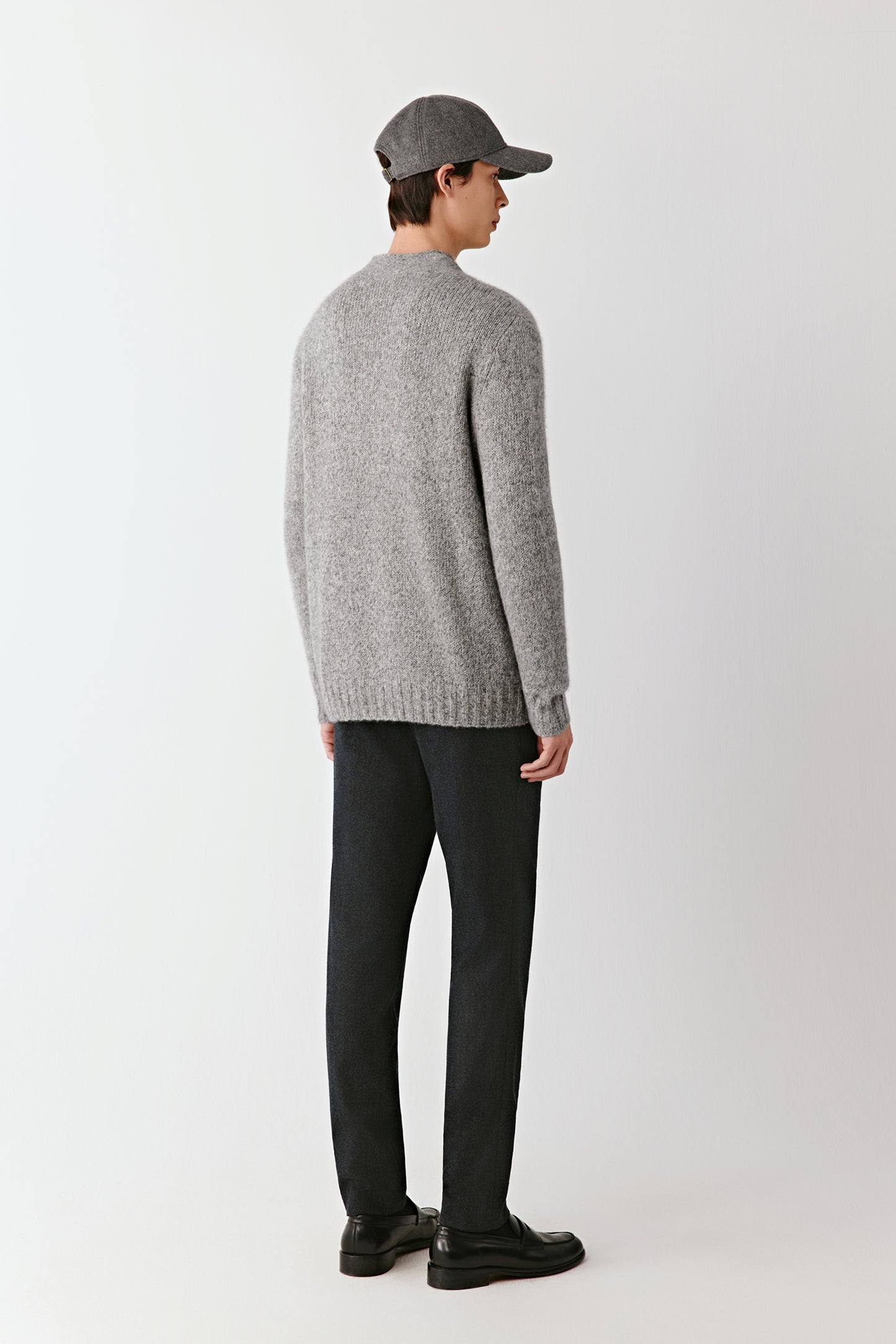 Back view of the grey cardigan, highlighting the clean lines and fine knit.