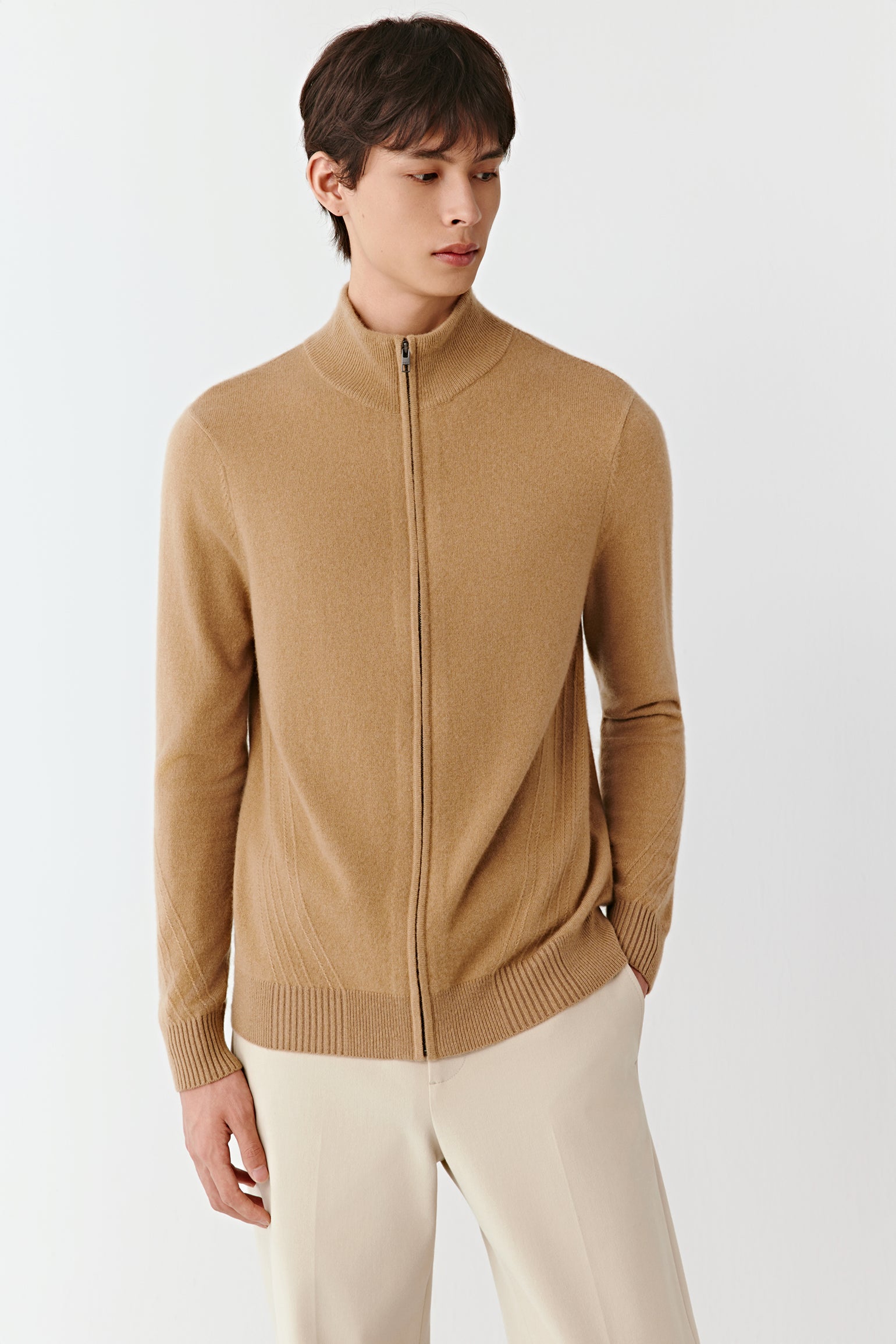 Three-quarter view of the cashmere cardigan, showing the soft texture and neat silhouette.