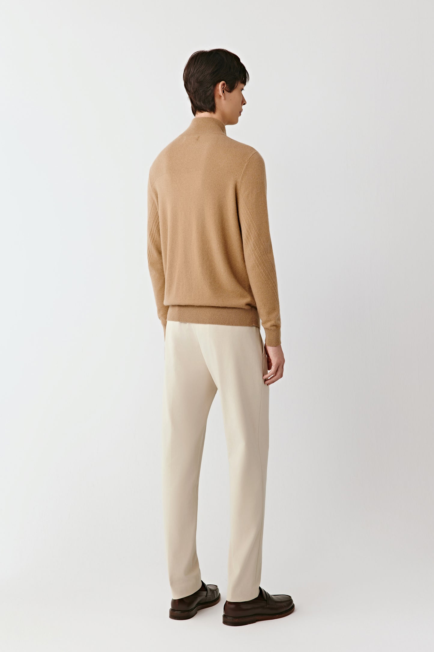 Back view of the camel zip cardigan, highlighting the smooth knit and clean lines.