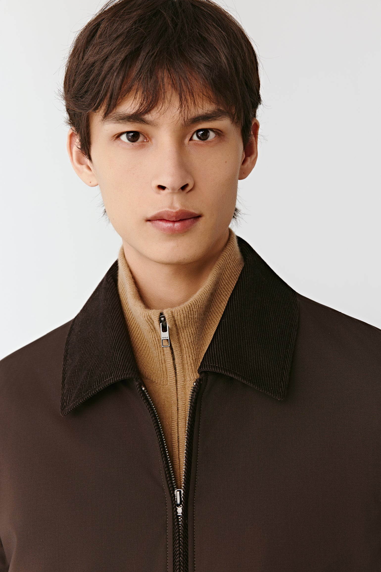 Close-up of the brown wool and yak jacket, focusing on the collar, zip closure, and refined stitching details.