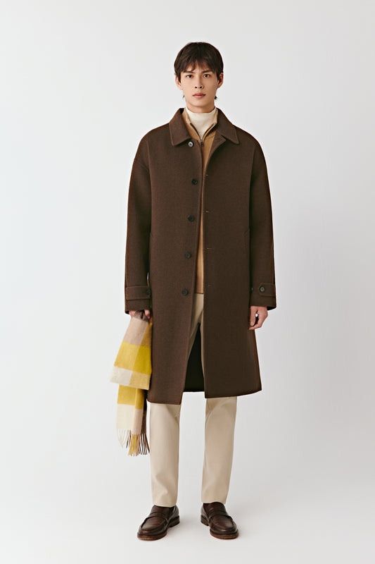 Front view of the chestnut-brown double-faced yak wool coat, featuring a point collar, side pockets, and a straight, fluid silhouette.