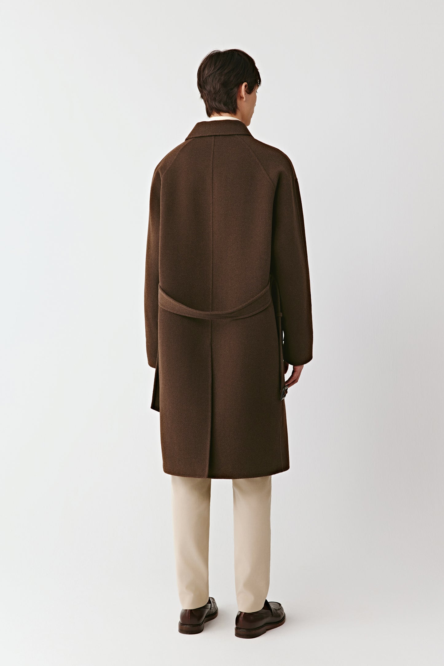 Back view of the brown double-faced yak wool coat, emphasizing the clean construction and natural flow of the fabric.