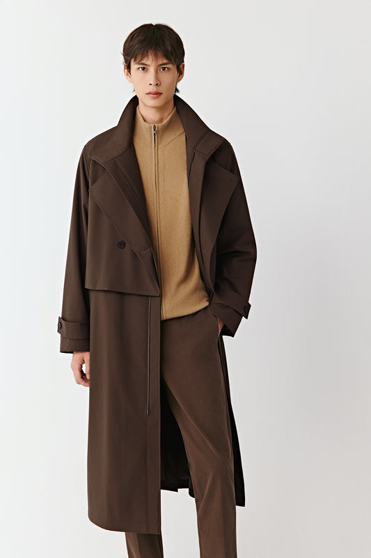 Three-quarter side view of the brown quilted coat, showing the elegant drape and structured silhouette.