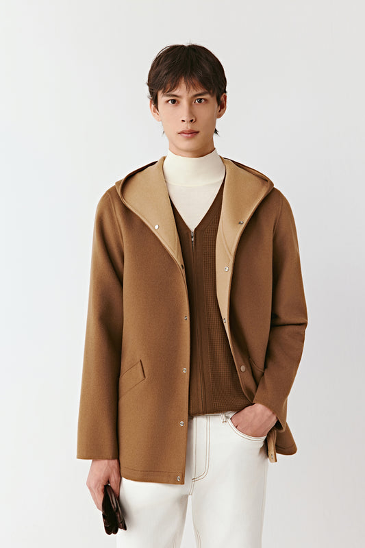 Three-quarter side view of the caramel brown hooded jacket, highlighting the wrap-around hood and relaxed fit.